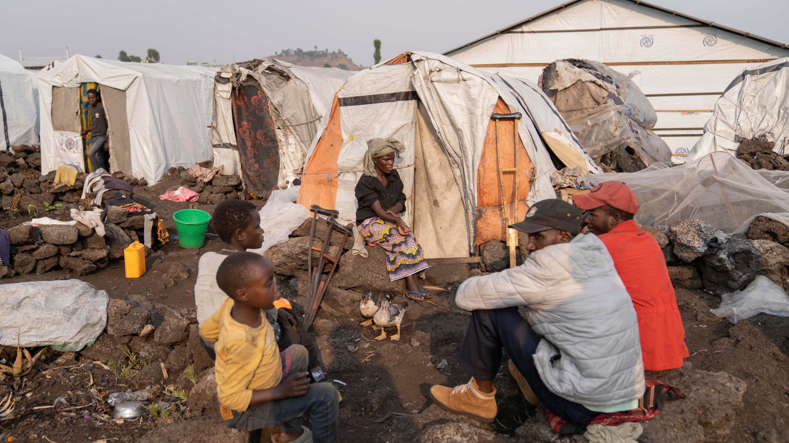 Sarah Bagheni, center back, in the Bulengo refugee camp in Goma, Congo, suspects she may be infected with Mpox after the World Health Organization had declared Thursday, Aug, 15, 2024, the increasing spread of mpox in Africa a global health emergency warning the virus might ultimately spill across international border. (AP Photo/Moses Sawasawa)