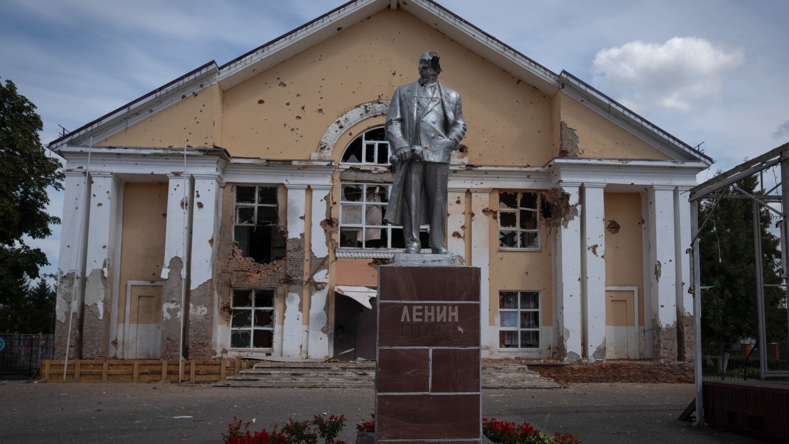 A damaged monument to Soviet founder Vladimir Lenin stands in a central square in Sudzha, Kursk region, Russia, Friday, Aug. 16, 2024. This image was approved by the Ukrainian Defense Ministry before publication. (AP Photo)