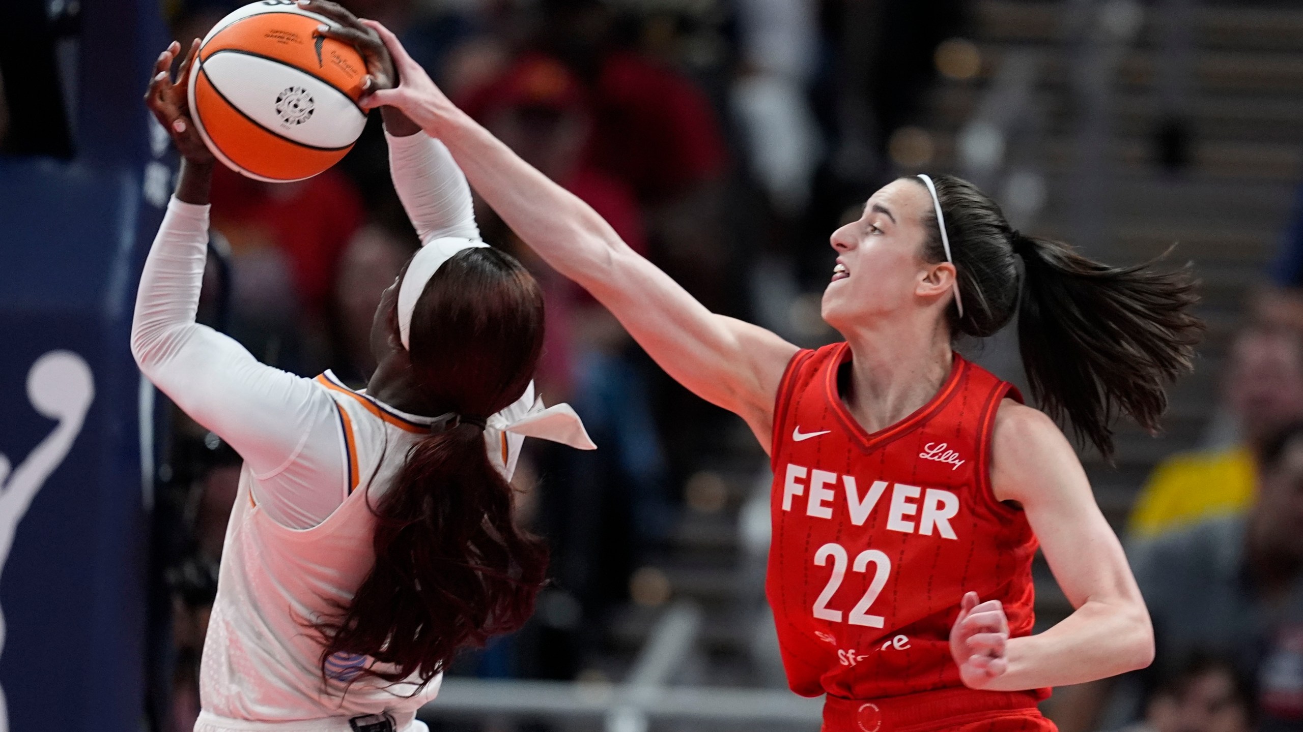 Phoenix Mercury's Kahleah Copper (2) is fouled by Indiana Fever's Caitlin Clark (22) during the second half of a WNBA basketball game, Friday, Aug. 16, 2024, in Indianapolis. (AP Photo/Darron Cummings)