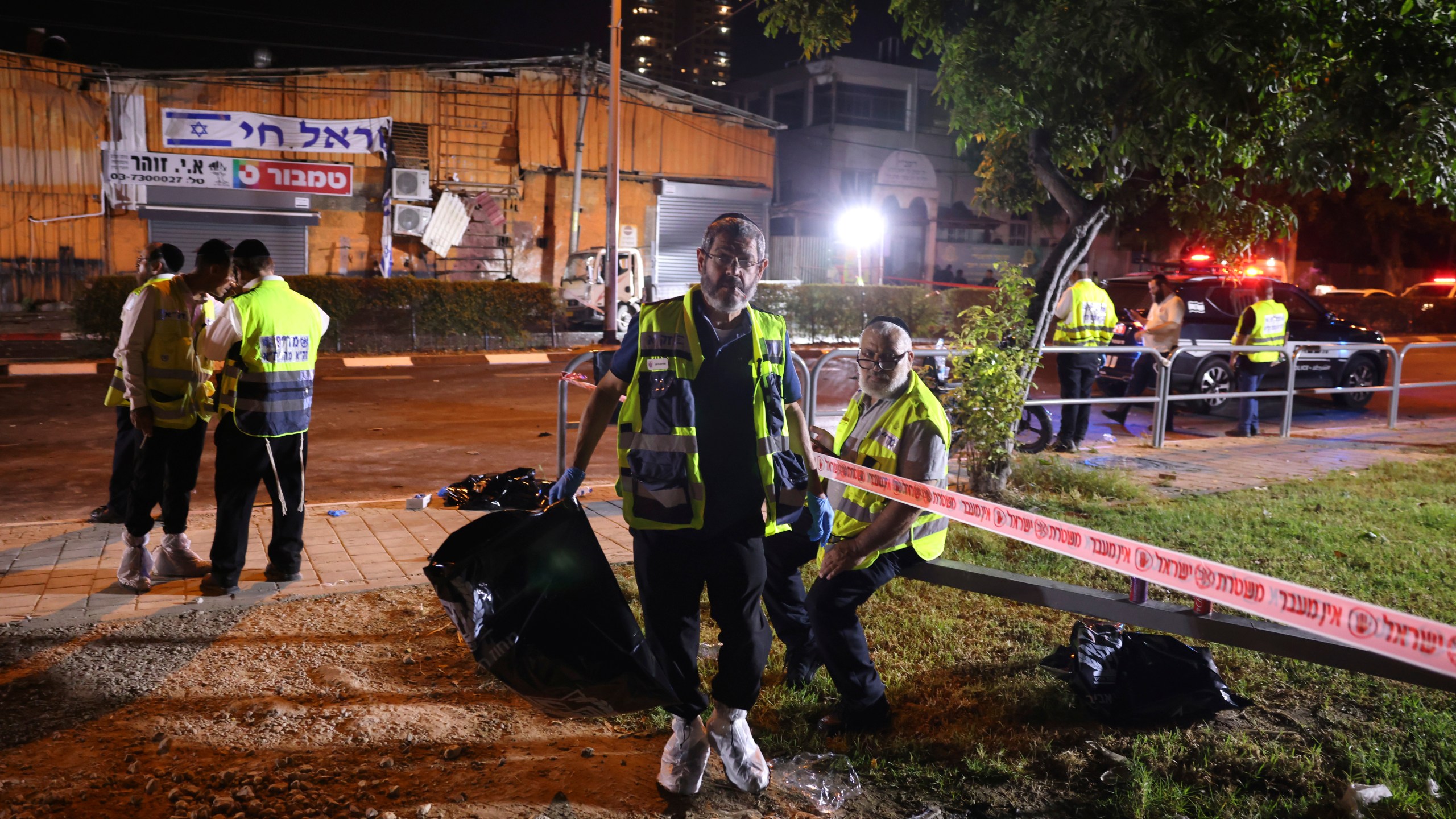 An Israeli ZAKA volunteer works at the scene of a bomb explosion in Tel Aviv, Israel, Sunday, Aug. 18, 2024. Israeli Police say one person was killed and another moderately injured. (AP Photo/Moti Milrod)