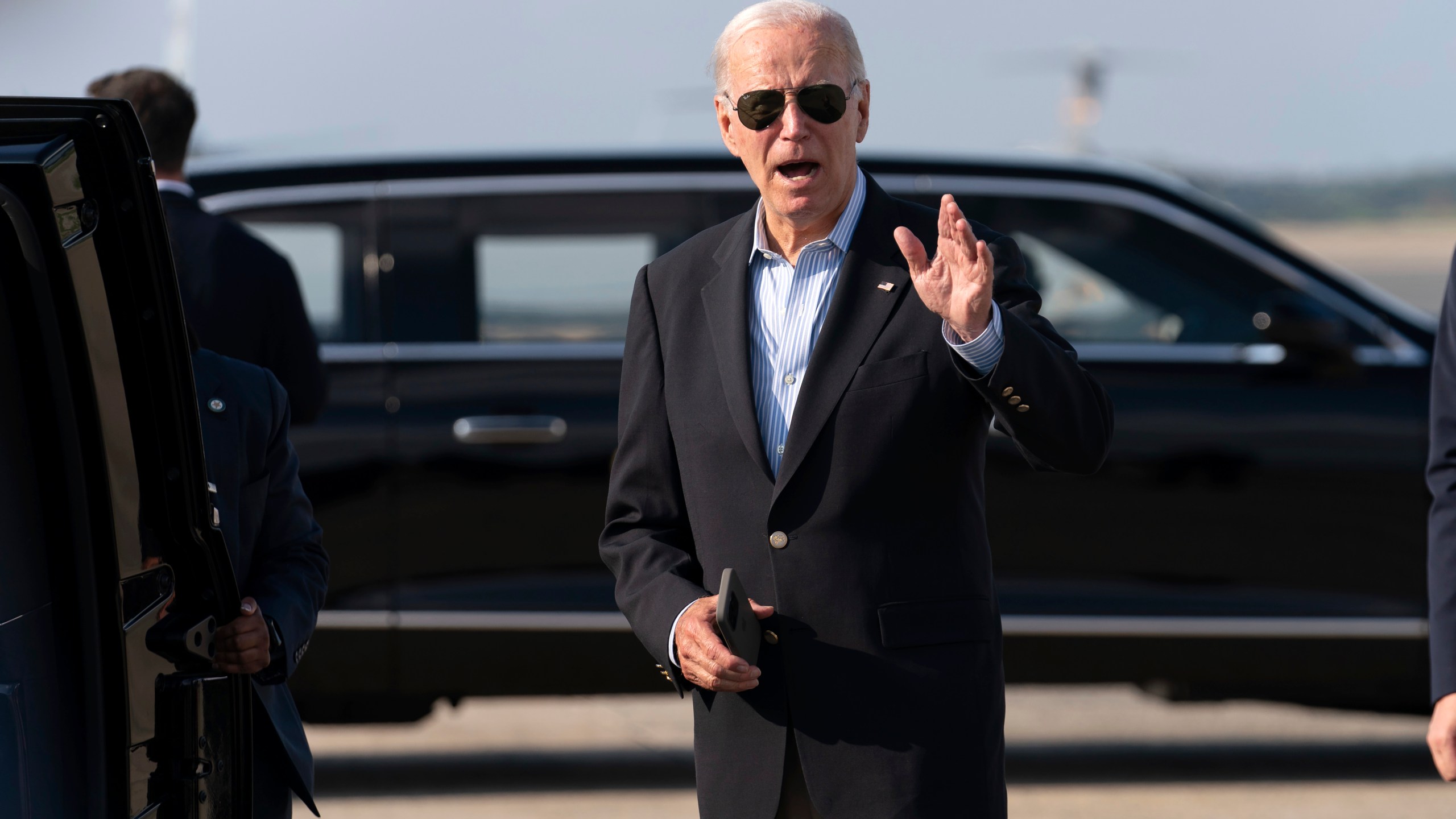 President Joe Biden talks to reporters upon his arrival to Joint Base Andrews, Md., en route to the White House, Sunday, Aug. 18, 2024. (AP Photo/Jose Luis Magana)