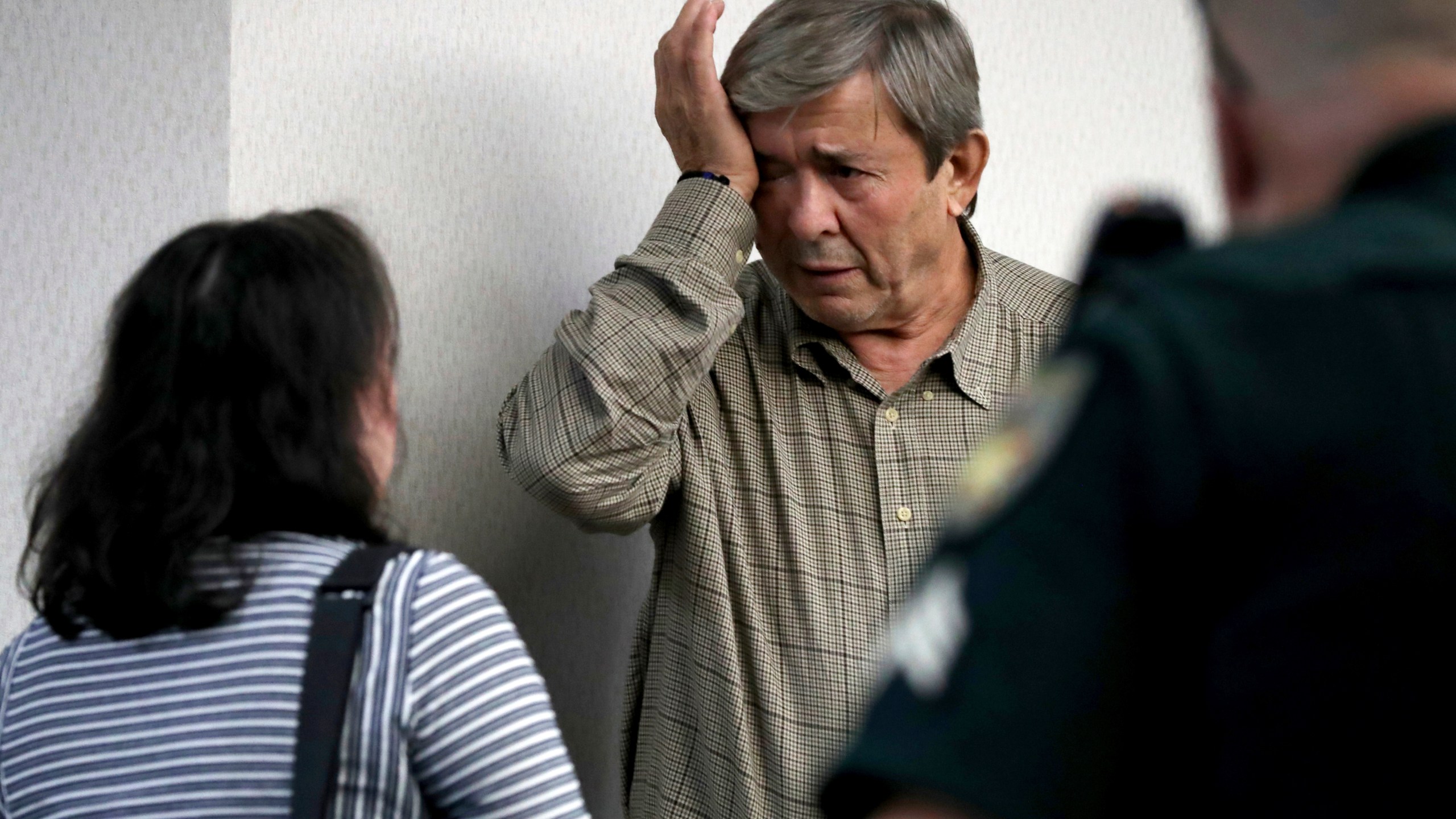 Antonios Pagourtzis, center, wipes away tears next to his wife, Rose Marie Kosmetatos, left, after a jury decided that they do not bear financial responsibility for the 2018 shooting at Santa Fe High School, Monday, Aug. 19, 2024, at the Galveston County Courthouse in Galveston, Texas. (Jennifer Reynolds/The Galveston County Daily News via AP, Pool)