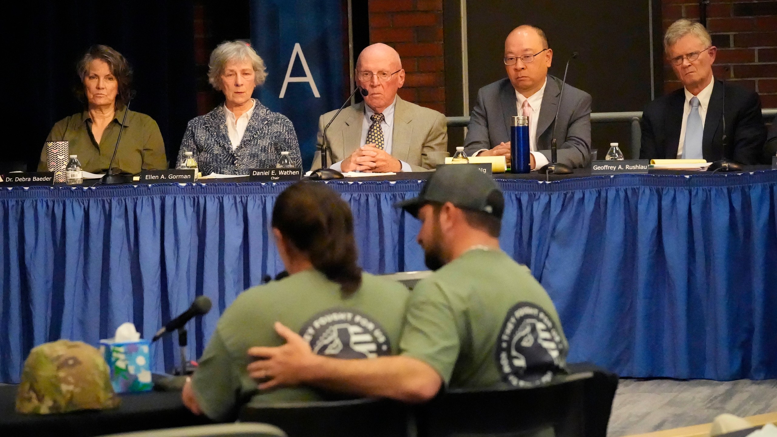 FILE — Members of the independent commission investigating the law enforcement response to the mass shooting in Lewiston, Maine, listen as Nicole Herling, below left, sister of shooter Robert Card, testifies Thursday, May 16, 2024, in Augusta, Maine. (AP Photo/Robert F. Bukaty, File)