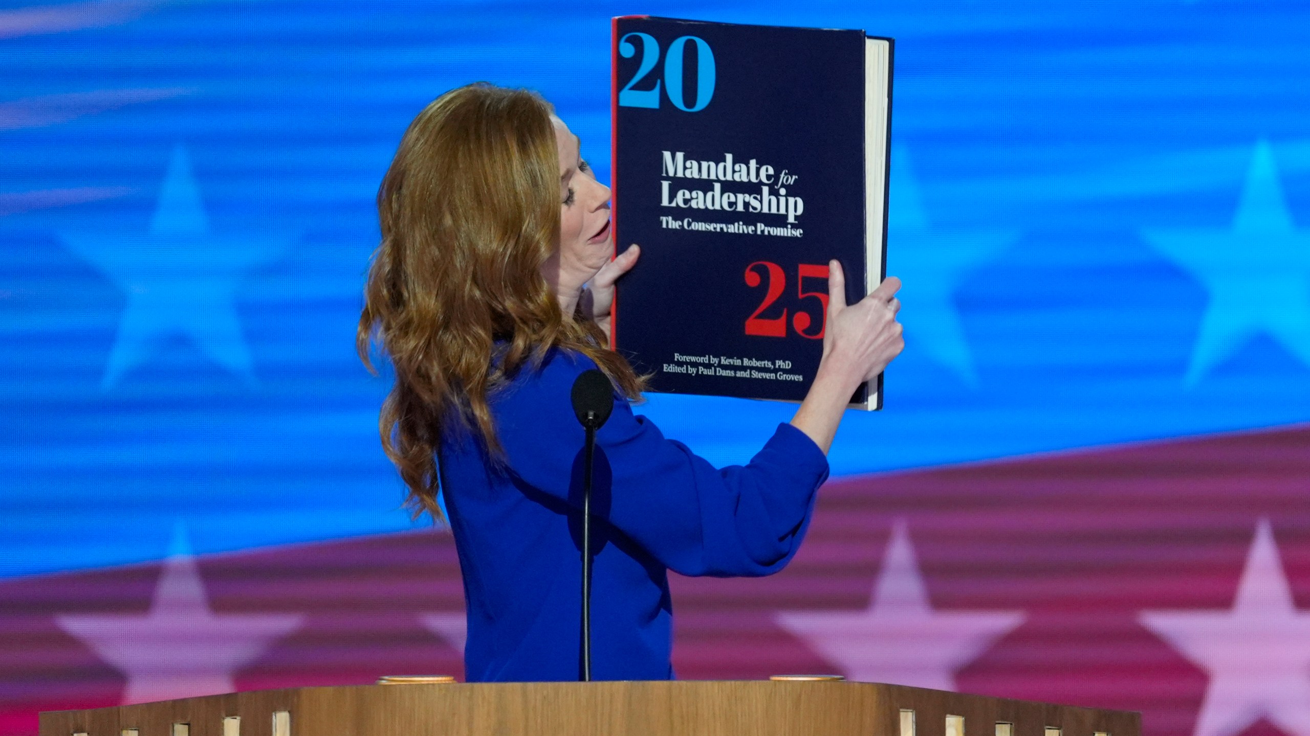 Michigan State Senator Mallory McMorrow holding up a book during her remarks at the Democratic National Convention on Monday, Aug. 19, 2024, in Chicago. (AP Photo/J. Scott Applewhite)