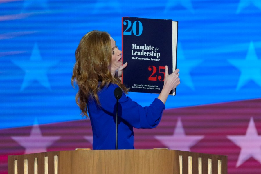 Michigan State Senator Mallory McMorrow holding up a book during her remarks at the Democratic National Convention on Monday, Aug. 19, 2024, in Chicago. (AP Photo/J. Scott Applewhite)