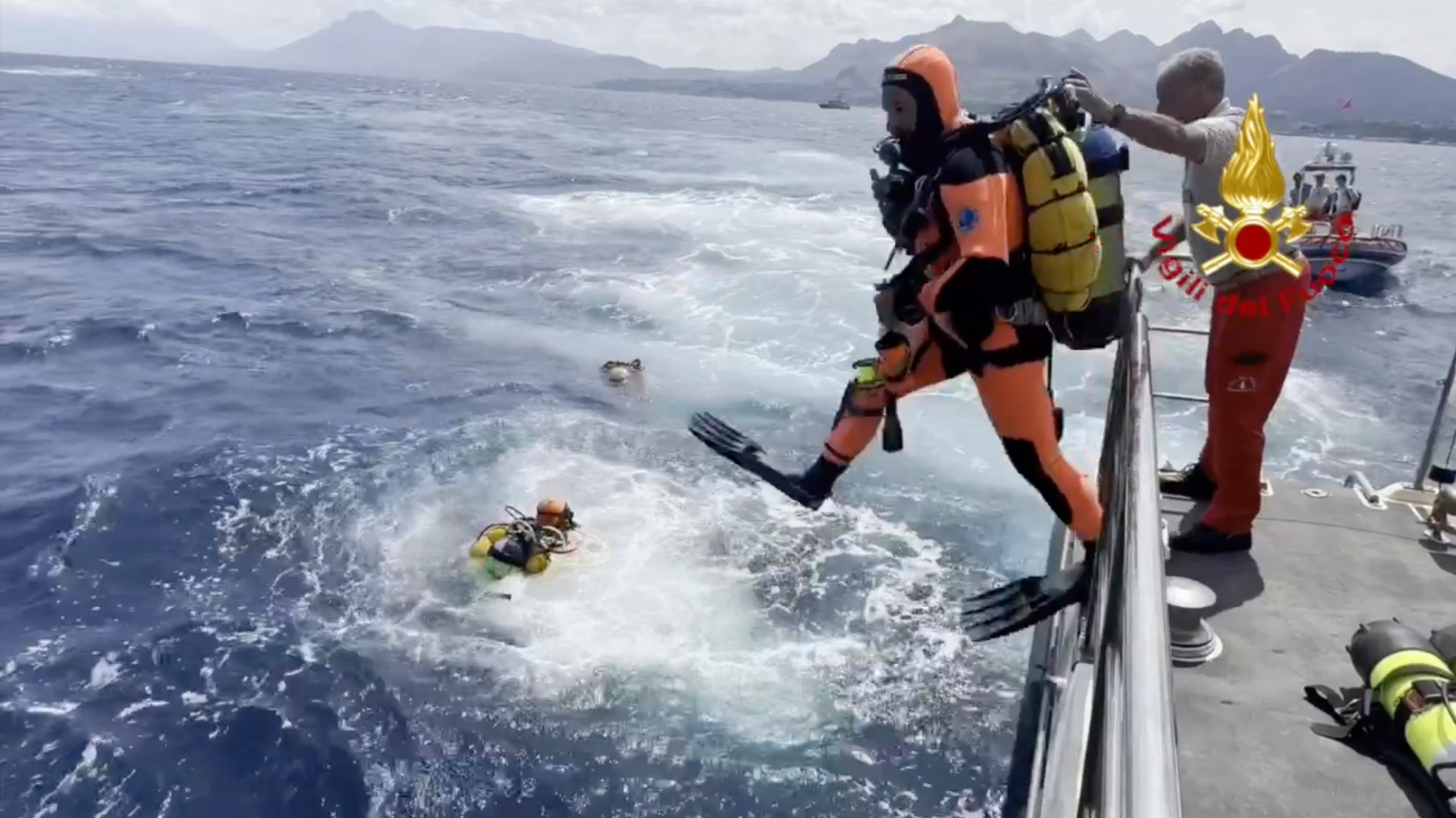 In this frame grab taken from a footage released by the Italian Firefighters Tuesday, Aug. 20, 2024, scuba divers on the scene scene of the search for a missing boat, in Porticello, southern Italy. Rescue teams and divers returned to the site of a storm-sunken superyacht Tuesday to search for six people, including British tech magnate Mike Lynch, who are believed to be still trapped in the hull 50 meters (164-feet) underwater. (Italian Firefighters via AP, HO)