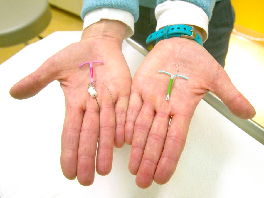 FILE - Dr. Susan Gorman displays the Skyla IUD, left, and the Mirena IUD, at High Lakes Gynecology in Redmond, Ore., Jan. 14, 2015. (Andy Tullis/The Bulletin via AP)