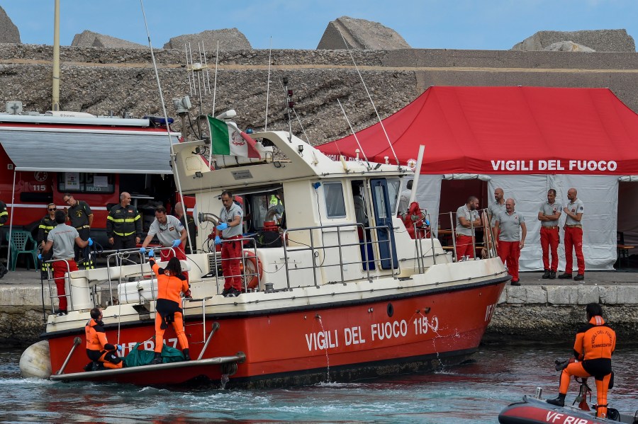 Italian firefighter divers bring ashore in a green bag the body of one of the victims of the UK flag vessel Bayesian, Wednesday, Aug. 21, 2024. The luxury sail yacht was hit by a violent sudden storm and sunk early Monday, while at anchor off the Sicilian village of Porticello near Palermo, in southern Italy. (AP Photo/Salvatore Cavalli)