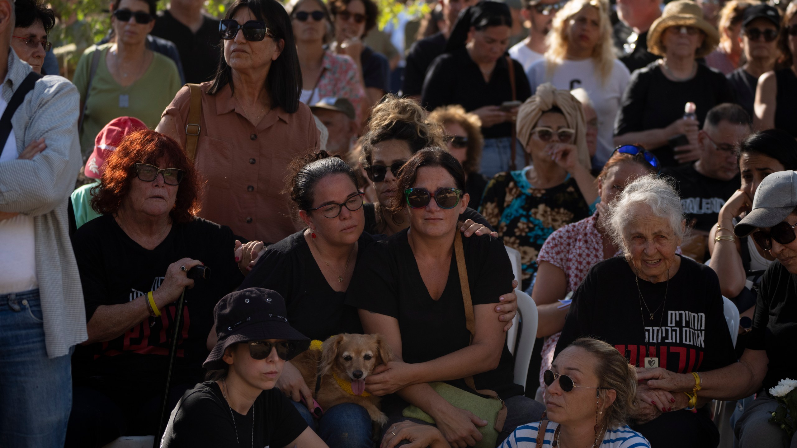 Rimon Buchshtab, center, mourns during the funeral of her husband Yagev Buchshtab at a cemetery of the kibbutz Nirim, southern Israel, Wednesday, Aug. 21, 2024. Buchshtab's body was one the six bodies of hostages, taken in Hamas' Oct. 7 attack, recovered by Israel's military during an operation in the Gaza Strip. (AP Photo/Leo Correa)