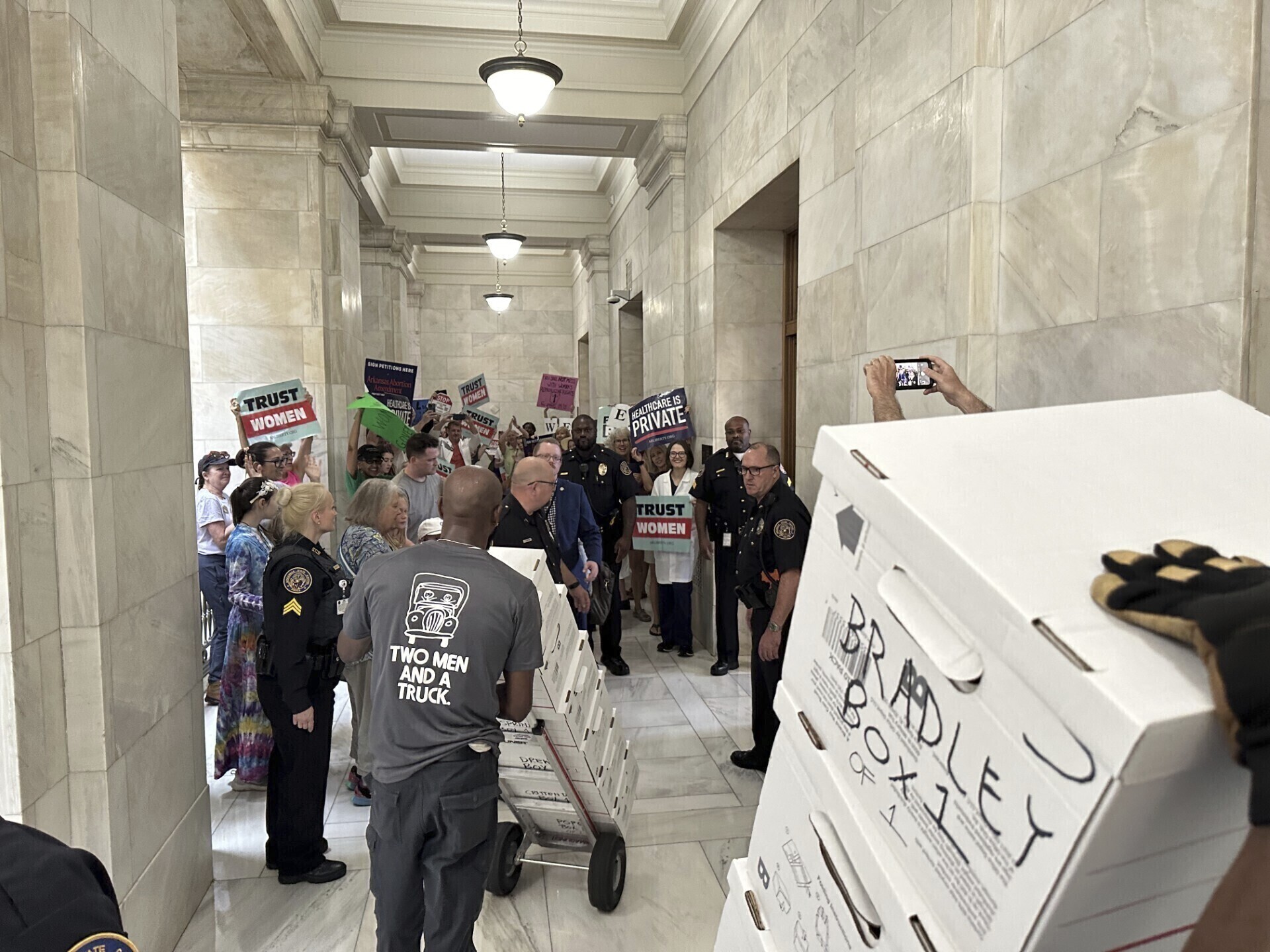 FILE - Boxes containing signatures supporting a proposed ballot measure to scale back Arkansas' abortion ban are delivered to a room in the state Capitol, July 5, 2024, in Little Rock, Ark. (AP Photo/Andrew DeMillo, File)