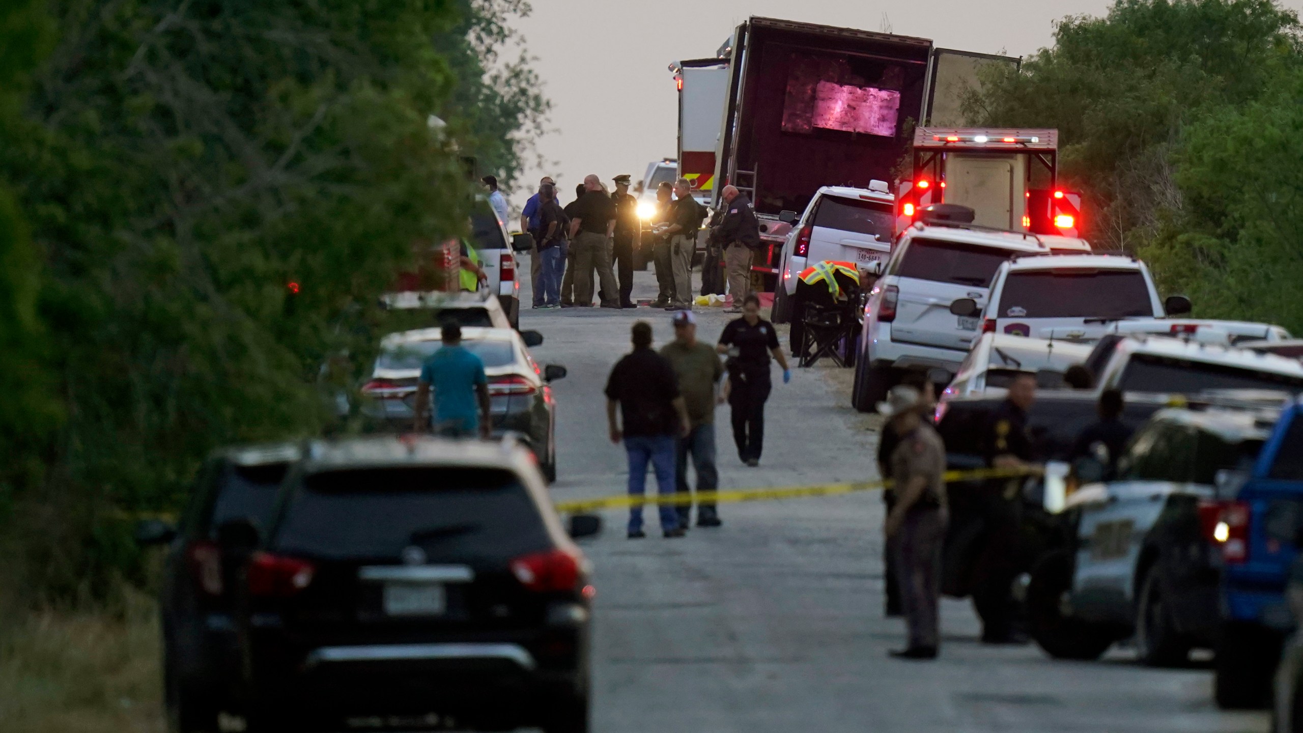 FILE - Police and other first responders work the scene where officials say dozens of people have been found dead and multiple others were taken to hospitals with heat-related illnesses after a tractor-trailer containing suspected migrants was found on June 27, 2022, in San Antonio. (AP Photo/Eric Gay, File)