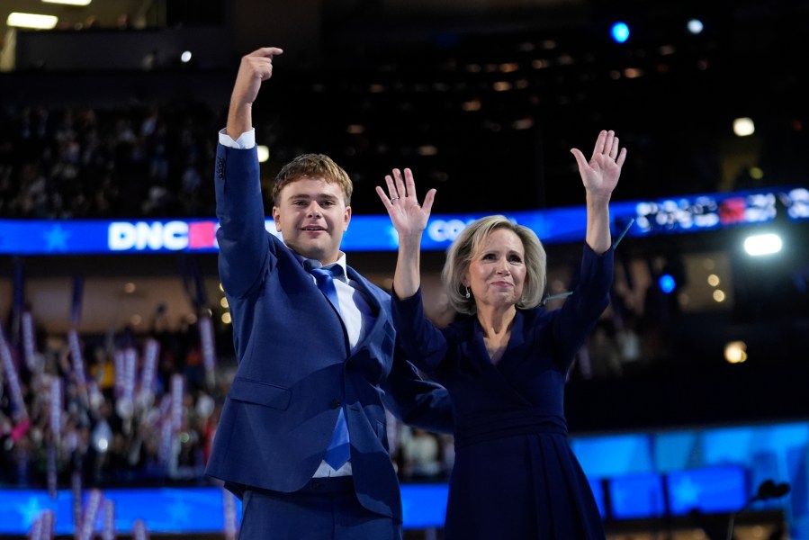 Democratic vice presidential nominee Minnesota Gov. Tim Walz's son Gus and wife Gwen react during the Democratic National Convention Wednesday, Aug. 21, 2024, in Chicago. (AP Photo/Paul Sancya)