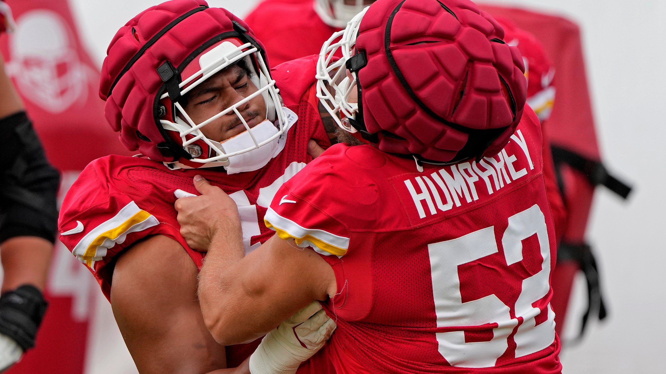 Kansas City Chiefs center Creed Humphrey (52) and offensive tackle Kingsley Suamataia (76) take part in a drill at NFL football training camp Wednesday, Aug. 14, 2024, in St. Joseph, Mo. (AP Photo/Charlie Riedel)