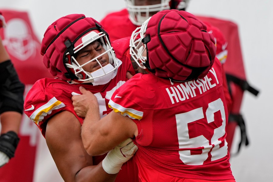 Kansas City Chiefs center Creed Humphrey (52) and offensive tackle Kingsley Suamataia (76) take part in a drill at NFL football training camp Wednesday, Aug. 14, 2024, in St. Joseph, Mo. (AP Photo/Charlie Riedel)