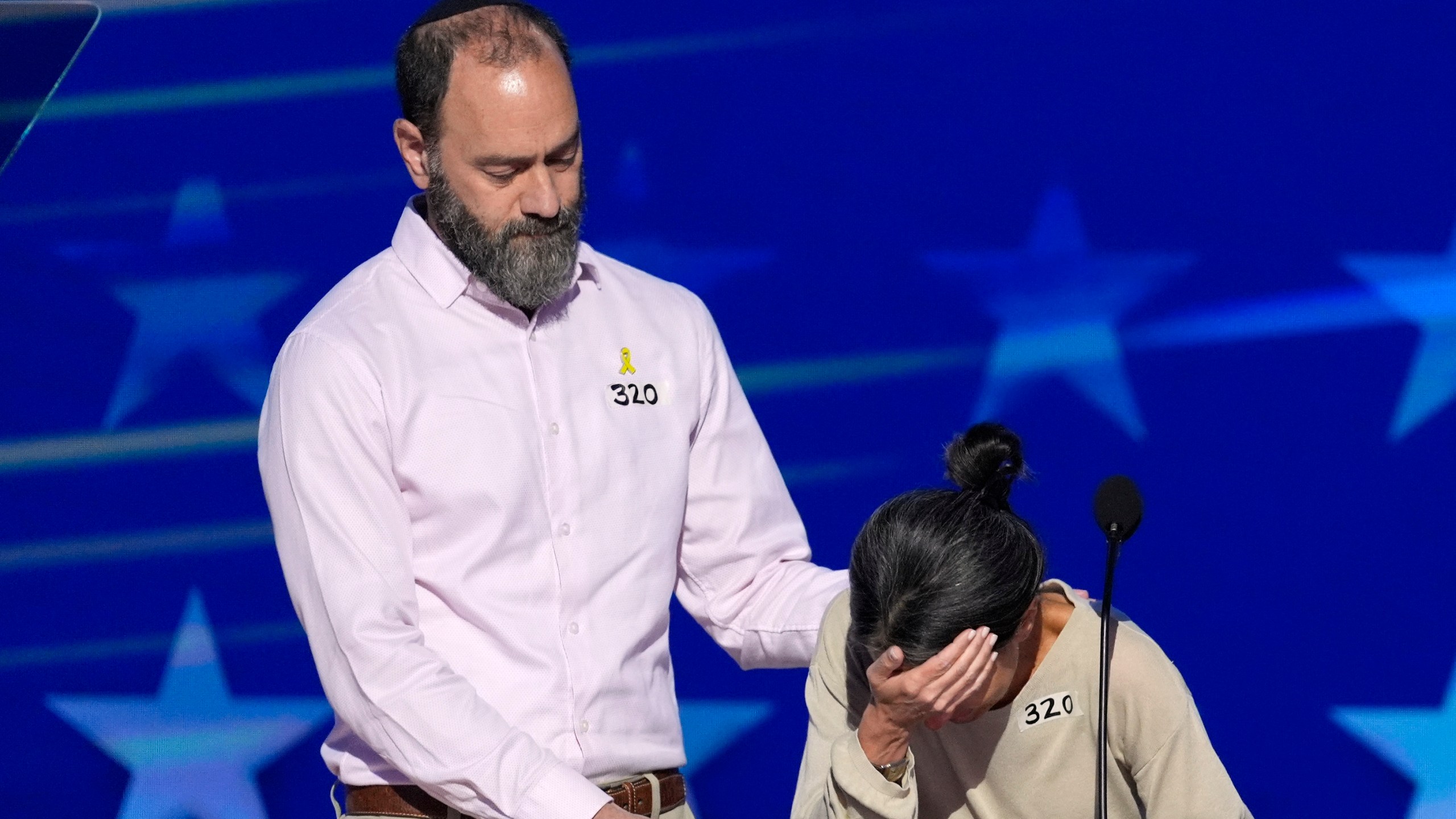 Jon Polin, left, and Rachel Goldberg, parents of Hersh Goldberg-Polin, speak on stage during the Democratic National Convention Wednesday, Aug. 21, 2024, in Chicago. (AP Photo/J. Scott Applewhite)