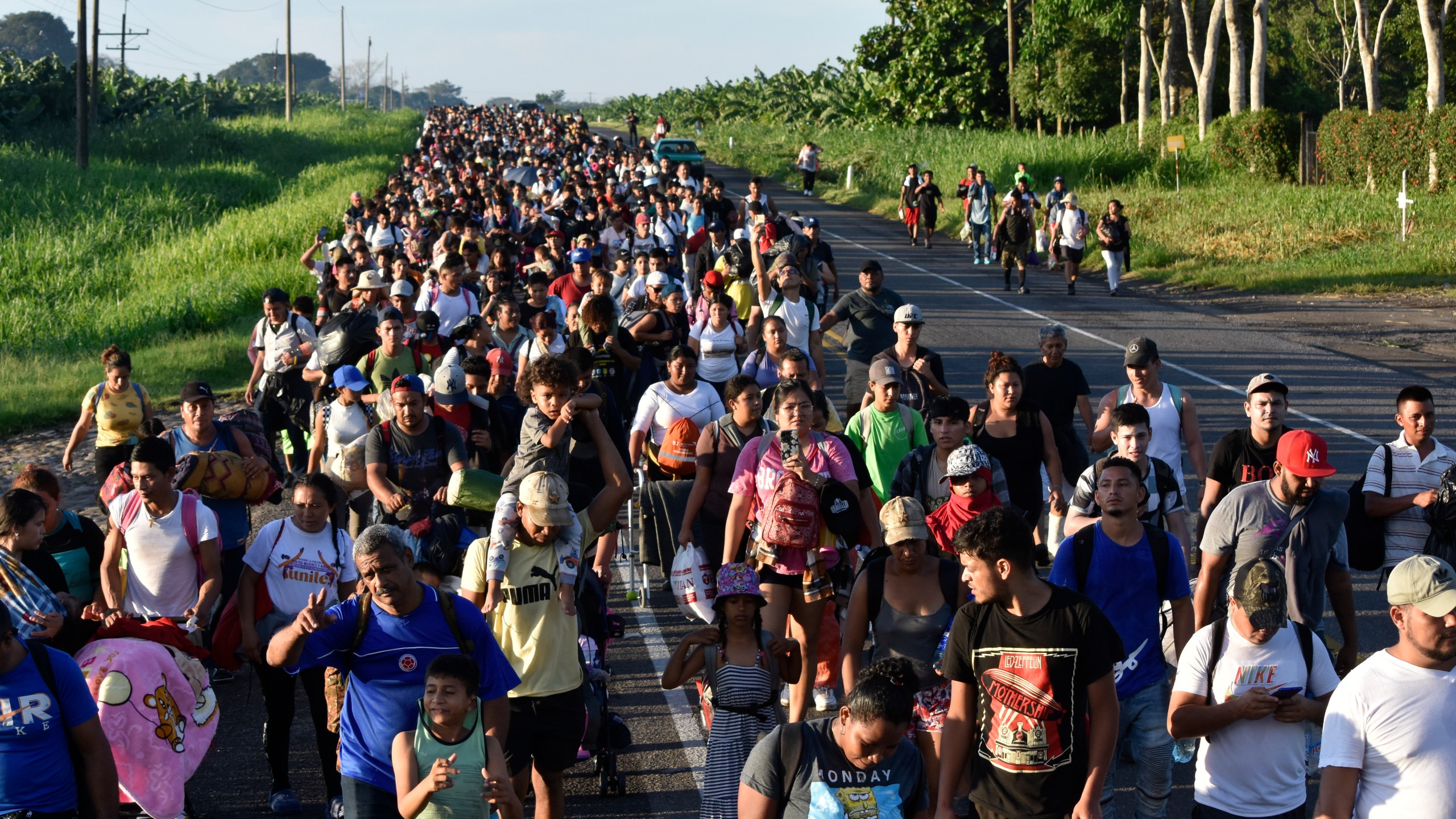 FILE - Migrants walk along the highway through Suchiate, Chiapas state in southern Mexico, July 21, 2024, during their journey north toward the U.S. border. (AP Photo/Edgar H. Clemente, File)