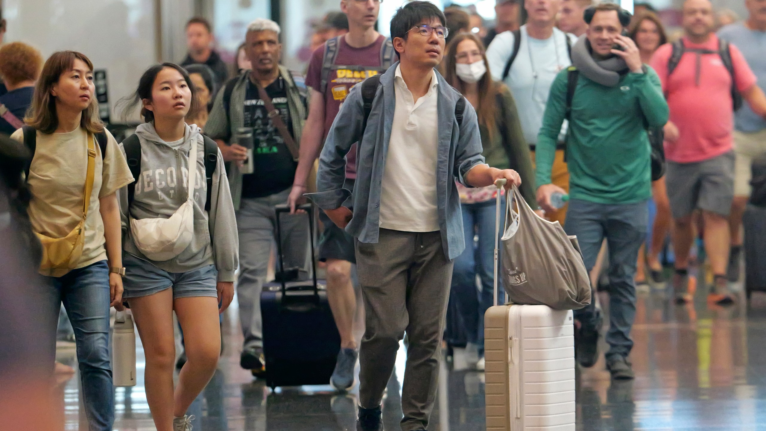 FILE - Travelers pass through Salt Lake City International Airport on July 3, 2024, in Salt Lake City. (AP Photo/Rick Bowmer, File)