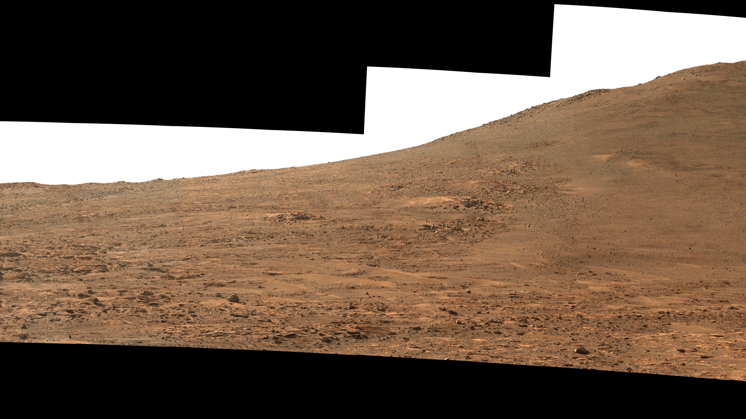 This image provided by NASA, taken by their Perseverance Mars rover, looks south towards the rim of Jezero Crater on Aug. 4, 2024. The panorama, which encompasses 80 degrees, is made up of 59 individual images stitched together after being sent back to Earth. The color has been enhanced to bring out subtle details. (NASA via AP)