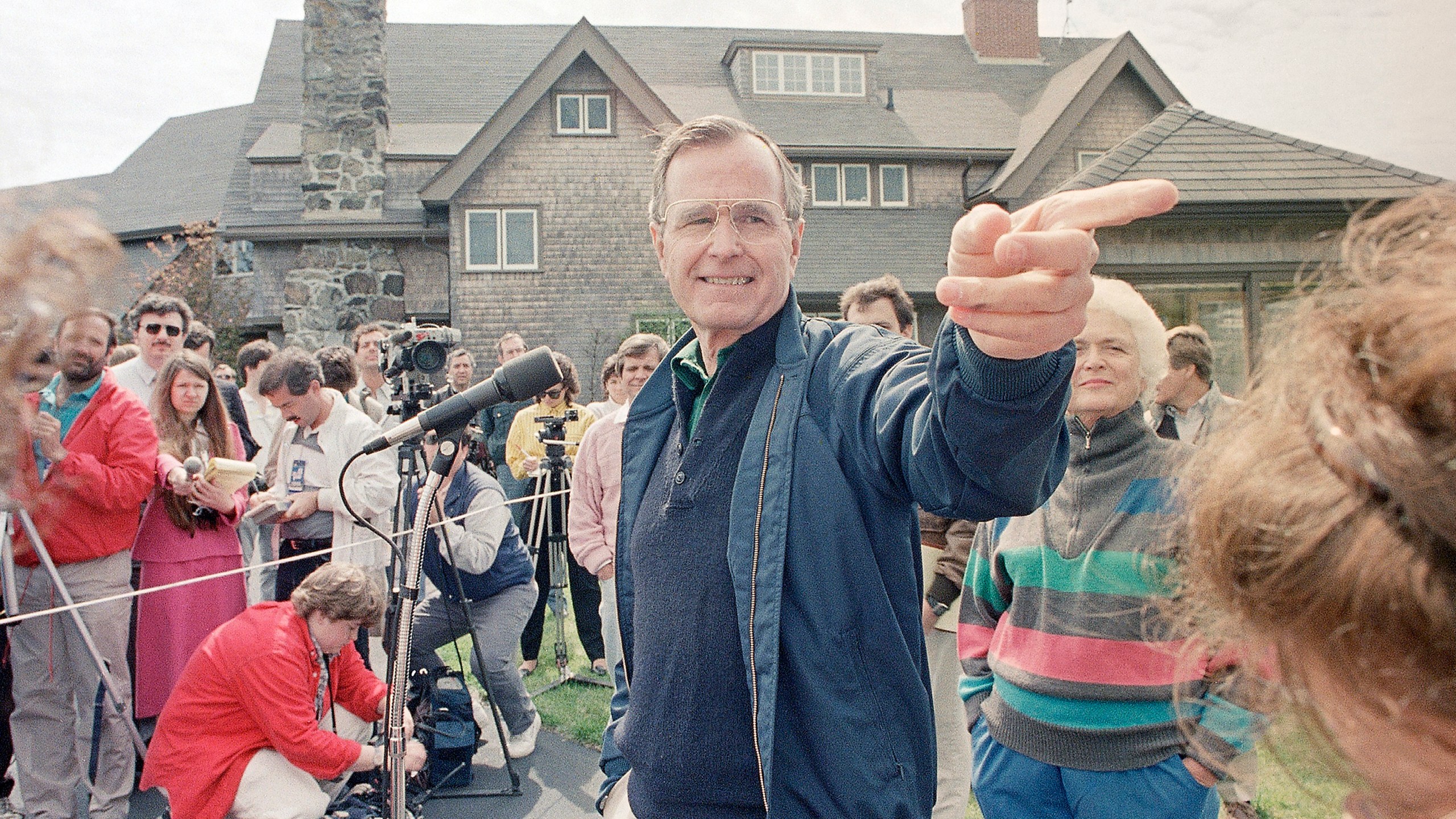 FILE - Vice President George Bush fields a question during a news conference in front of his Kennebunkport, Maine, home, May 27, 1988, with his wife, Barbara, right. (AP Photo/Pat Wellenbach, File)