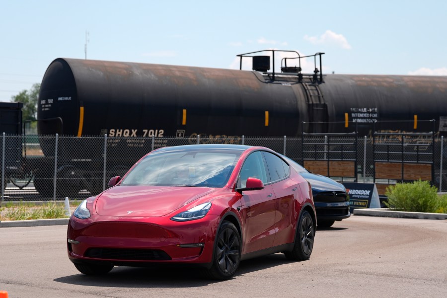 FILE - Drivers guide 2024 a Tesla Model 3 sedan and Model X utility vehicle, rear, along a test track at the Electrify Expo in The Yards on July 14, 2024, in north Denver. (AP Photo/David Zalubowski, File)