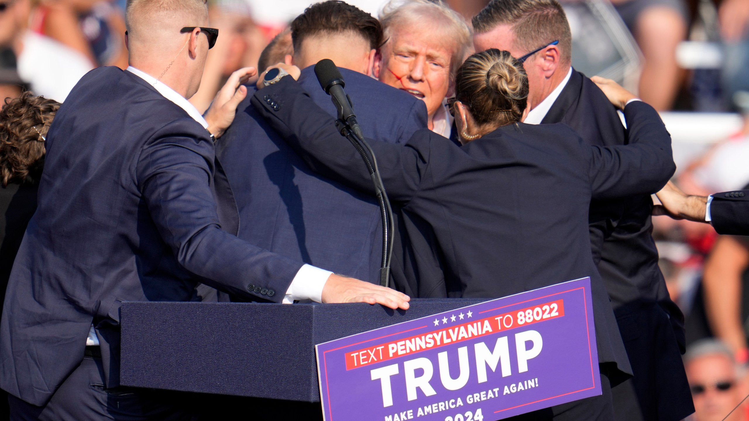 FILE - Republican presidential candidate former President Donald Trump is surrounded by Secret Service at a campaign event in Butler, Pa., July 13, 2024. A senior FBI official says the gunman in the assassination attempt of former President Donald Trump searched online for events of both Trump and President Joe Biden and saw the Pennsylvania campaign rally where he opened fire last month as a “target of opportunity." (AP Photo/Gene J. Puskar, File)