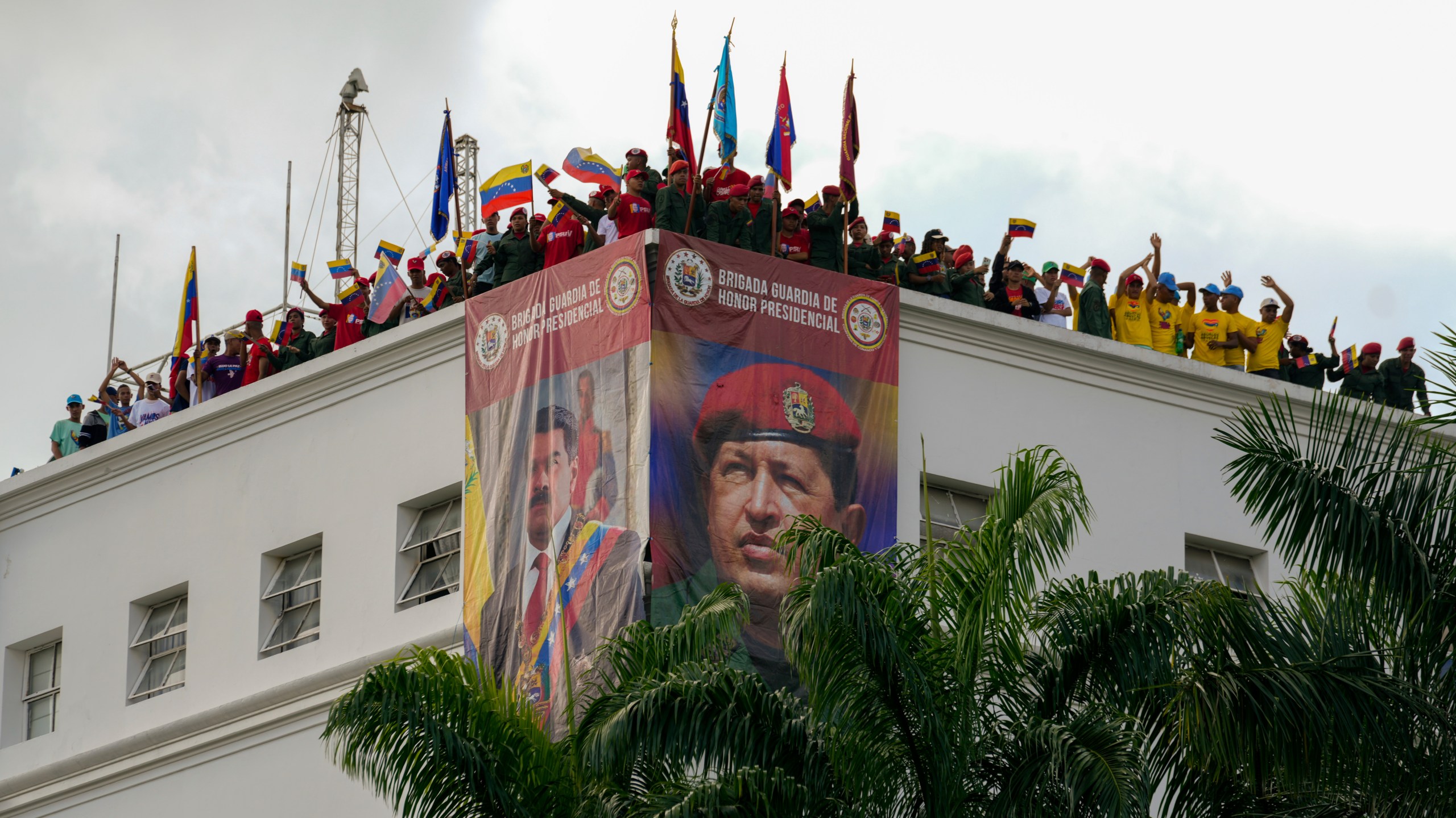 Members of the presidential guard listen to Venezuela's President Nicolas Maduro addressing government loyalists gathered at the presidential palace in support of his reelection one month after the presidential vote, in Caracas, Venezuela, Wednesday, Aug. 28, 2024. (AP Photo/Ariana Cubillos)