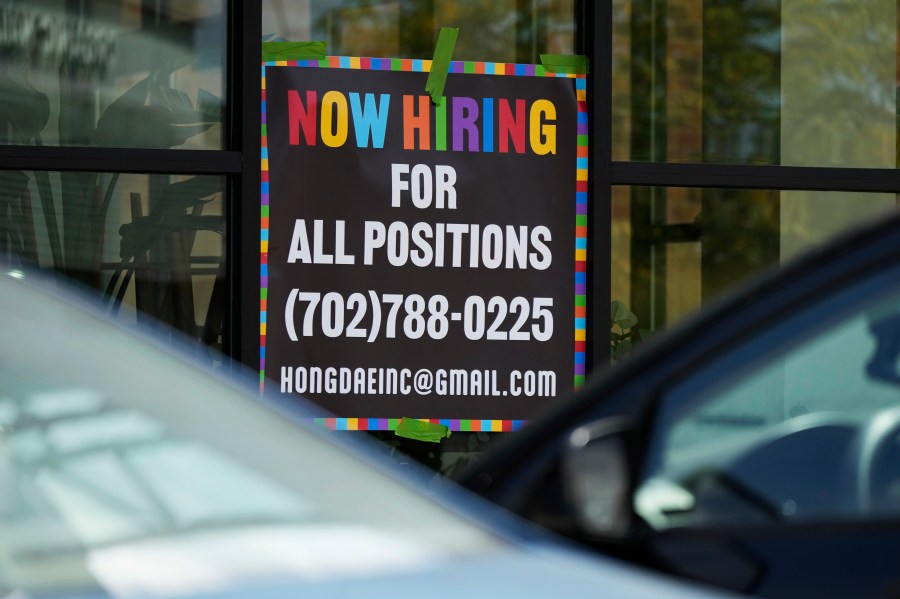 A hiring sign is displayed at a restaurant in Mount Prospect, Ill., Tuesday, Aug. 27, 2024. (AP Photo/Nam Y. Huh)