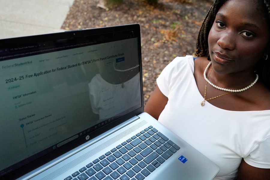 Adjovi Golo holds a laptop at DePaul University in Chicago, Wednesday, Aug. 28, 2024. (AP Photo/Nam Y. Huh)