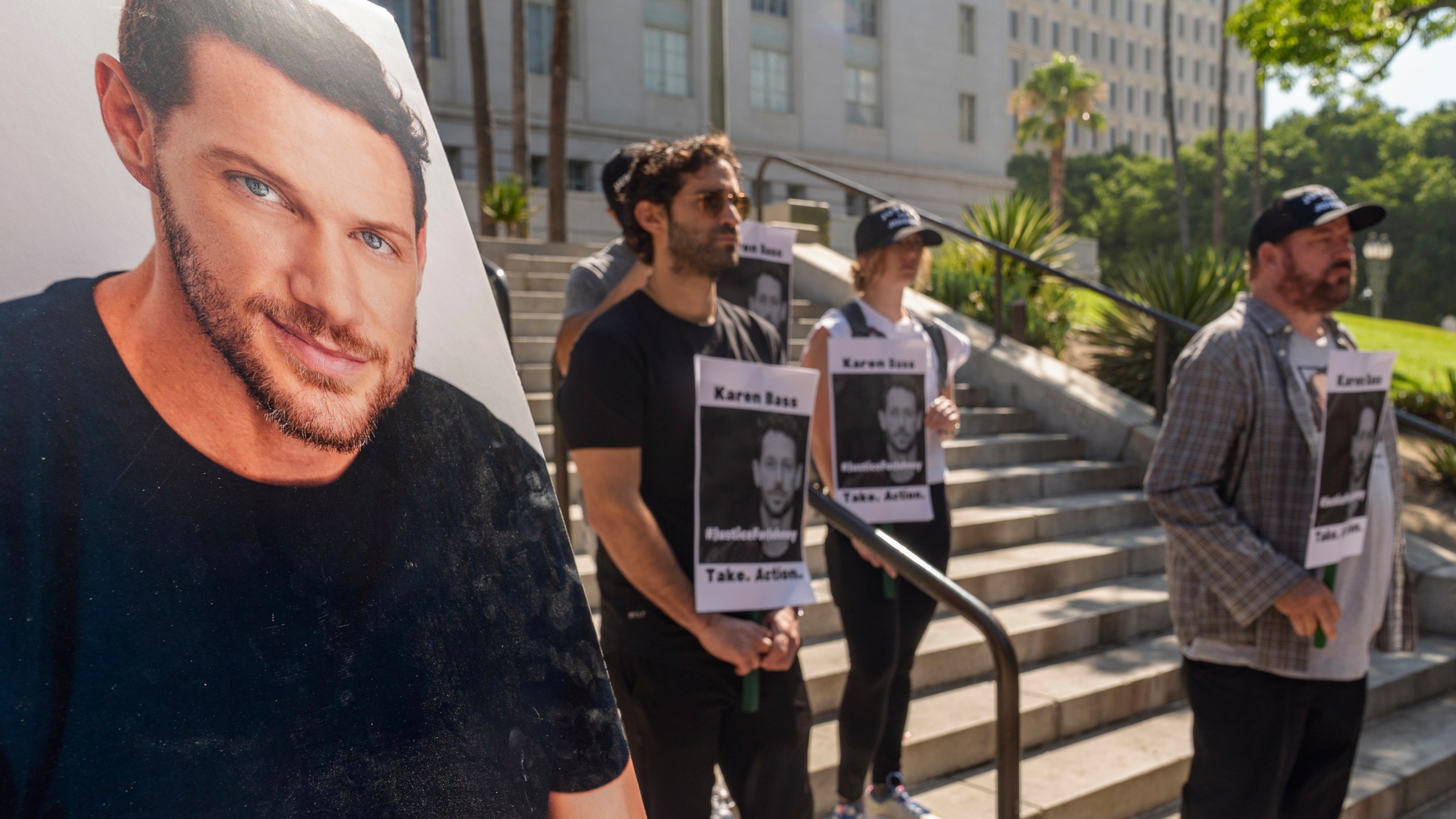 Friends and supporters of late actor Johnny Wactor, pictured left, hold a news conference to demand justice for the former "General Hospital" actor during a news conference outside Los Angeles City Hall in Los Angeles Tuesday, Aug.13, 2024. (AP Photo/Damian Dovarganes)