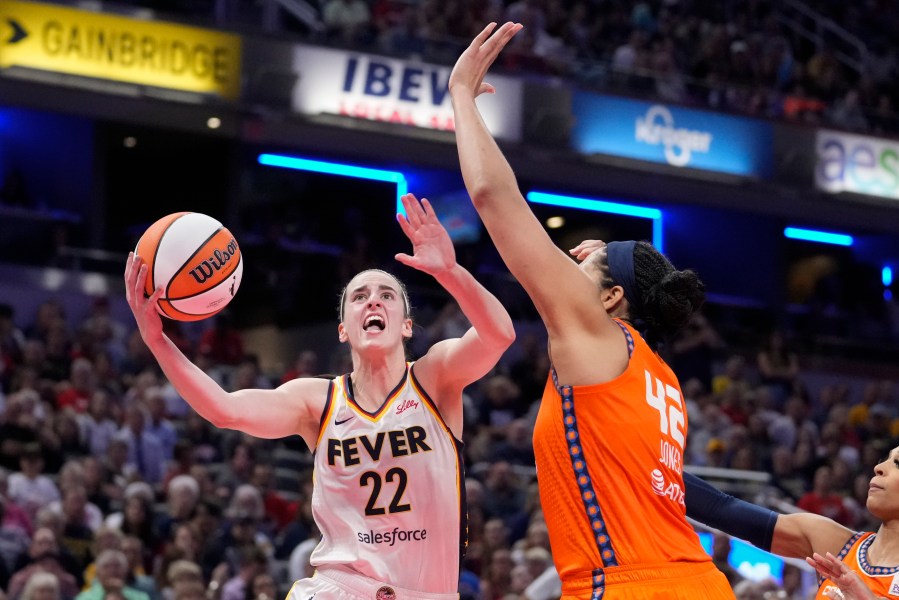 Indiana Fever guard Caitlin Clark (22) shot over Connecticut Sun forward Brionna Jones (42) in the second half of a WNBA basketball game in Indianapolis, Wednesday, Aug. 28, 2024. (AP Photo/Michael Conroy)