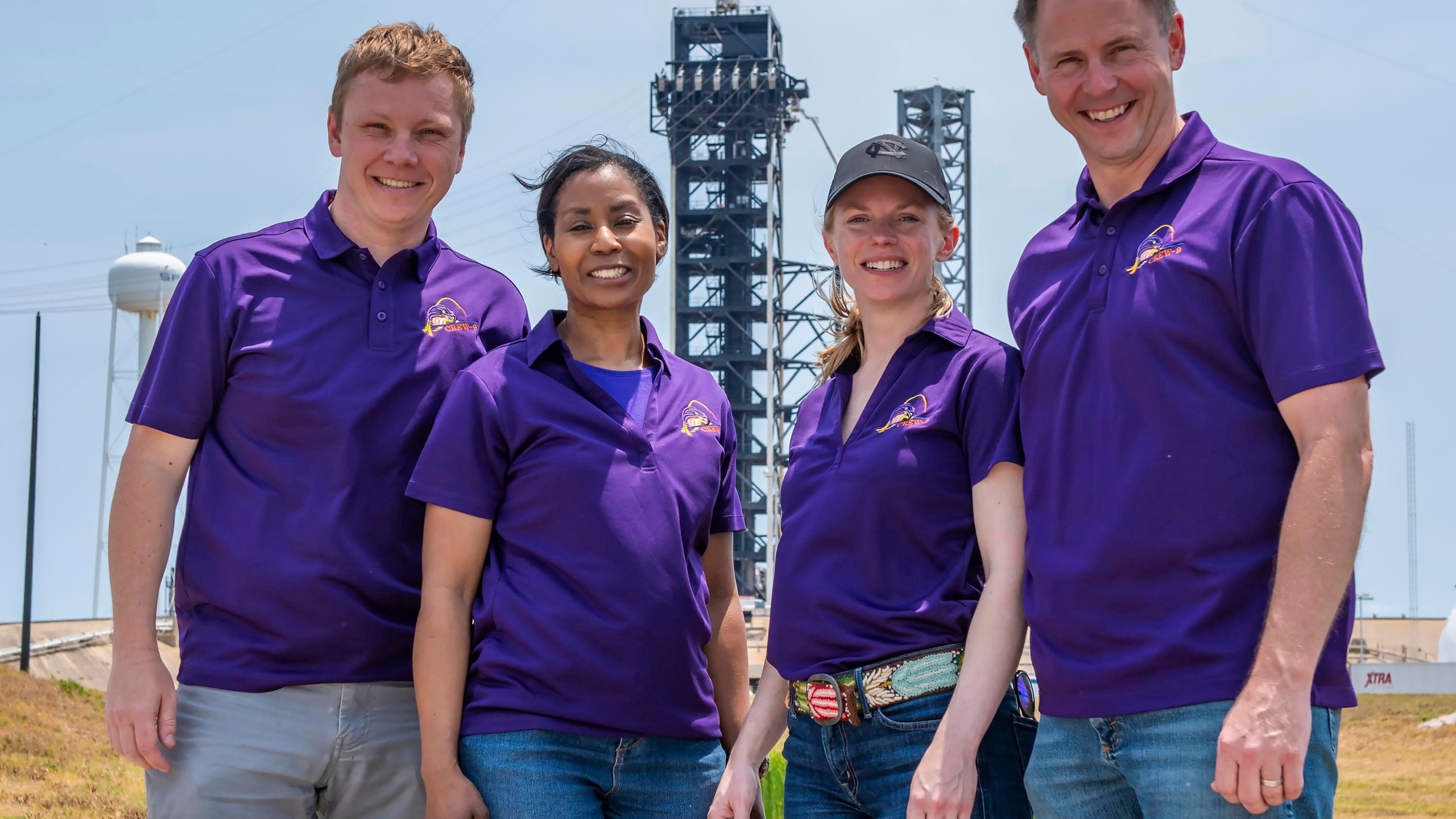 In this photo provided by SpaceX in July 2024, from left, Russian Aleksandr Gorbunov, and NASA's Stephanie Wilson, Zena Cardman and Nick Hague stand together for a group photo in front of the launch tower at Launch Complex 39A at the Kennedy Space Center in Florida. (SpaceX via AP)