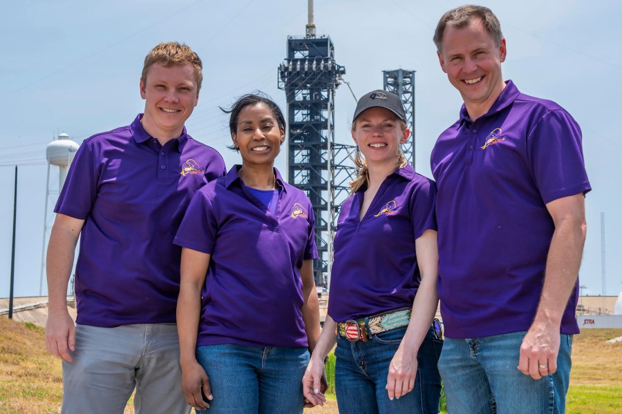 In this photo provided by SpaceX in July 2024, from left, Russian Aleksandr Gorbunov, and NASA's Stephanie Wilson, Zena Cardman and Nick Hague stand together for a group photo in front of the launch tower at Launch Complex 39A at the Kennedy Space Center in Florida. (SpaceX via AP)