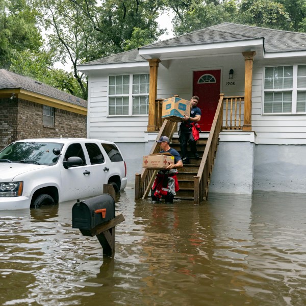 Savannah Fire Advanced Firefighters Ron Strauss and Andrew Stevenson carry food to residents in Savannah, Georgia