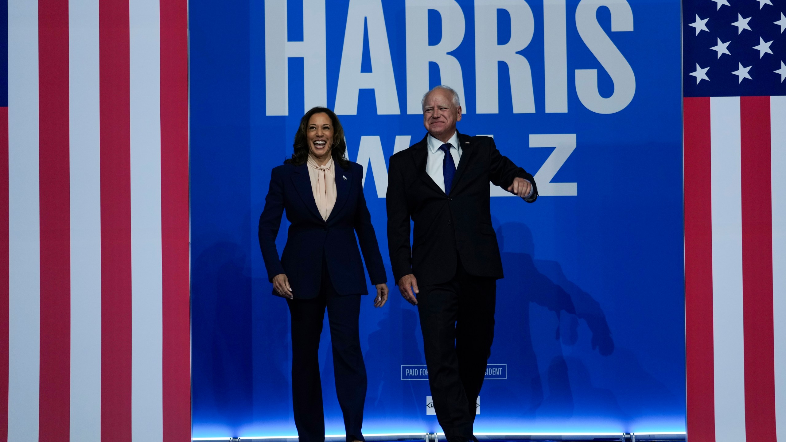 Democratic presidential nominee Vice President Kamala Harris and her running mate Minnesota Gov. Tim Walz arrive at a campaign rally in Philadelphia.