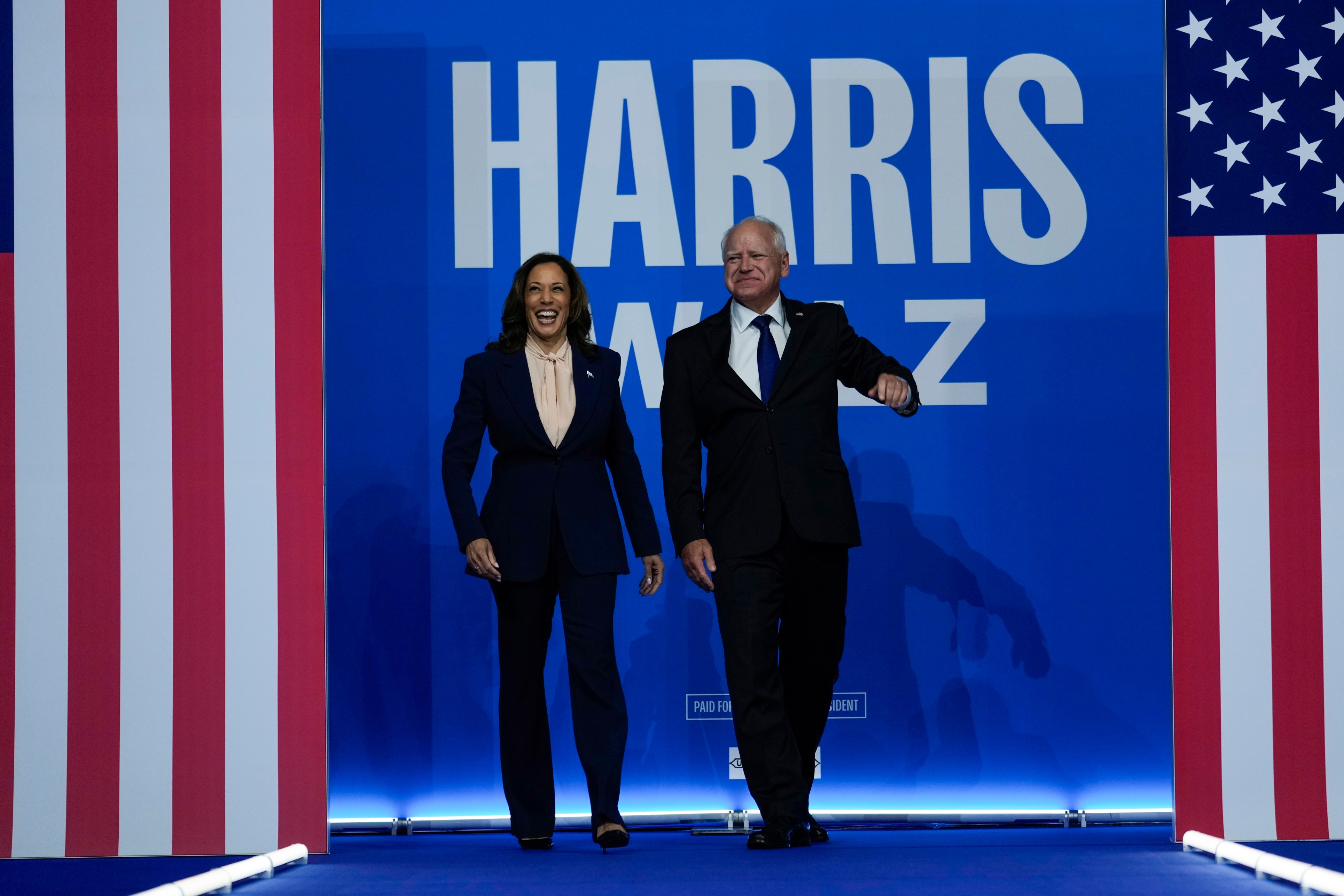 Democratic presidential nominee Vice President Kamala Harris and her running mate Minnesota Gov. Tim Walz arrive at a campaign rally in Philadelphia.