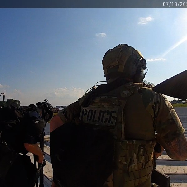 Law enforcement officers with guns.