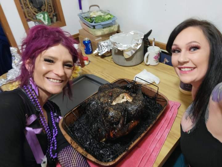 Two women, one with pink hair, and a burned turkey.