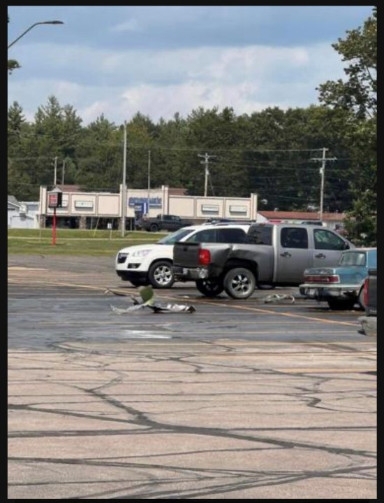 Fuel tank debris in a parking lot.