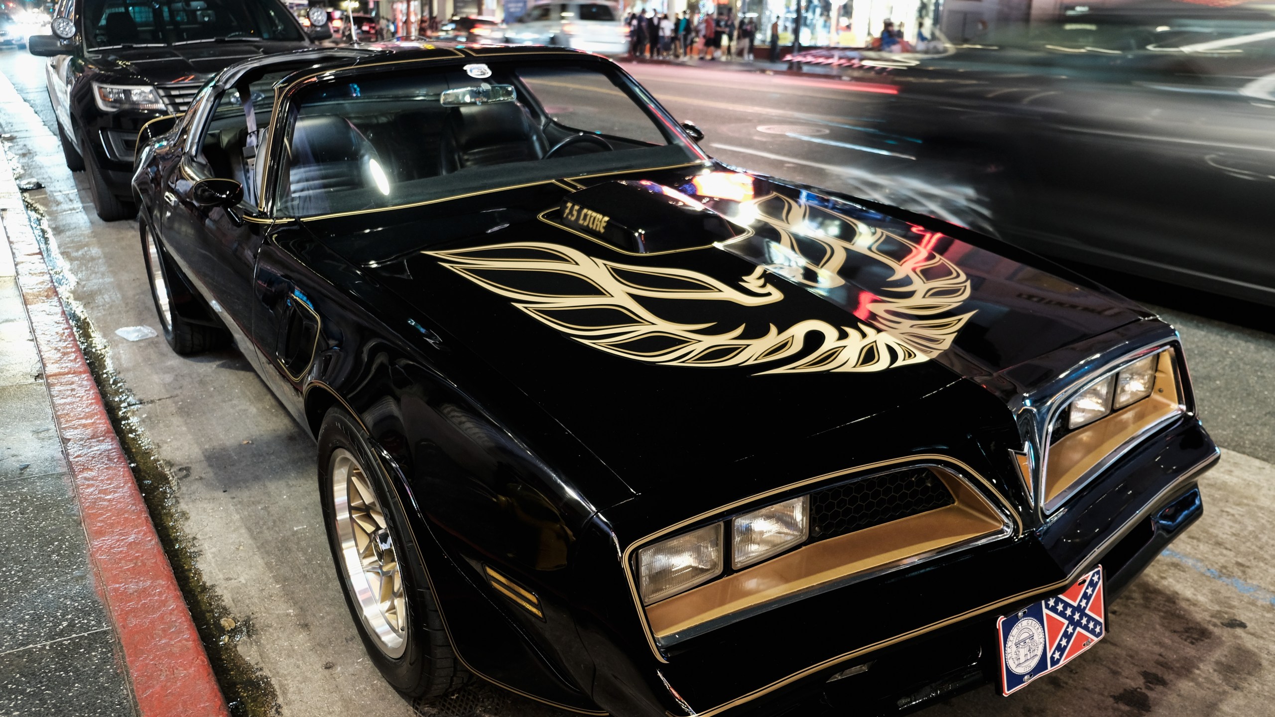 A Pontiac Firebird Trans Am similar to the one from Burt Reynold's film "Smokey and the Bandit" is seen in front of Burt Reynold's star on the Hollywood Walk of Fame in 2018.