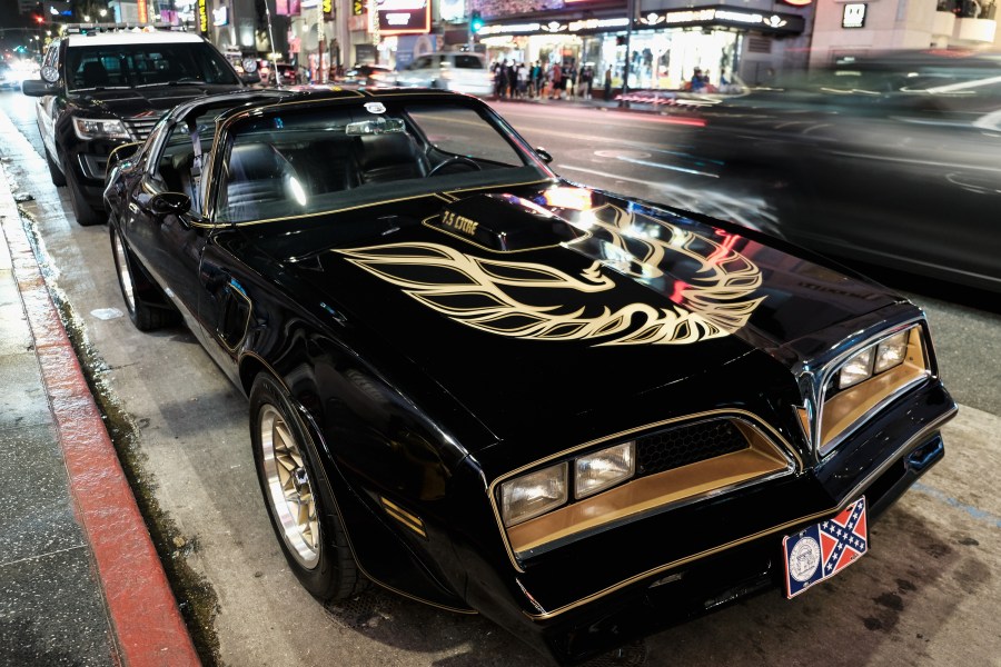 A Pontiac Firebird Trans Am similar to the one from Burt Reynold's film "Smokey and the Bandit" is seen in front of Burt Reynold's star on the Hollywood Walk of Fame in 2018.