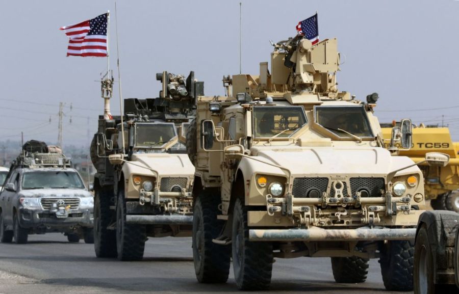 FILE: A convoy of US military vehicles arrives near the Iraqi Kurdish town of Bardarash in the Dohuk governorate after withdrawing from northern Syria on October 21, 2019.