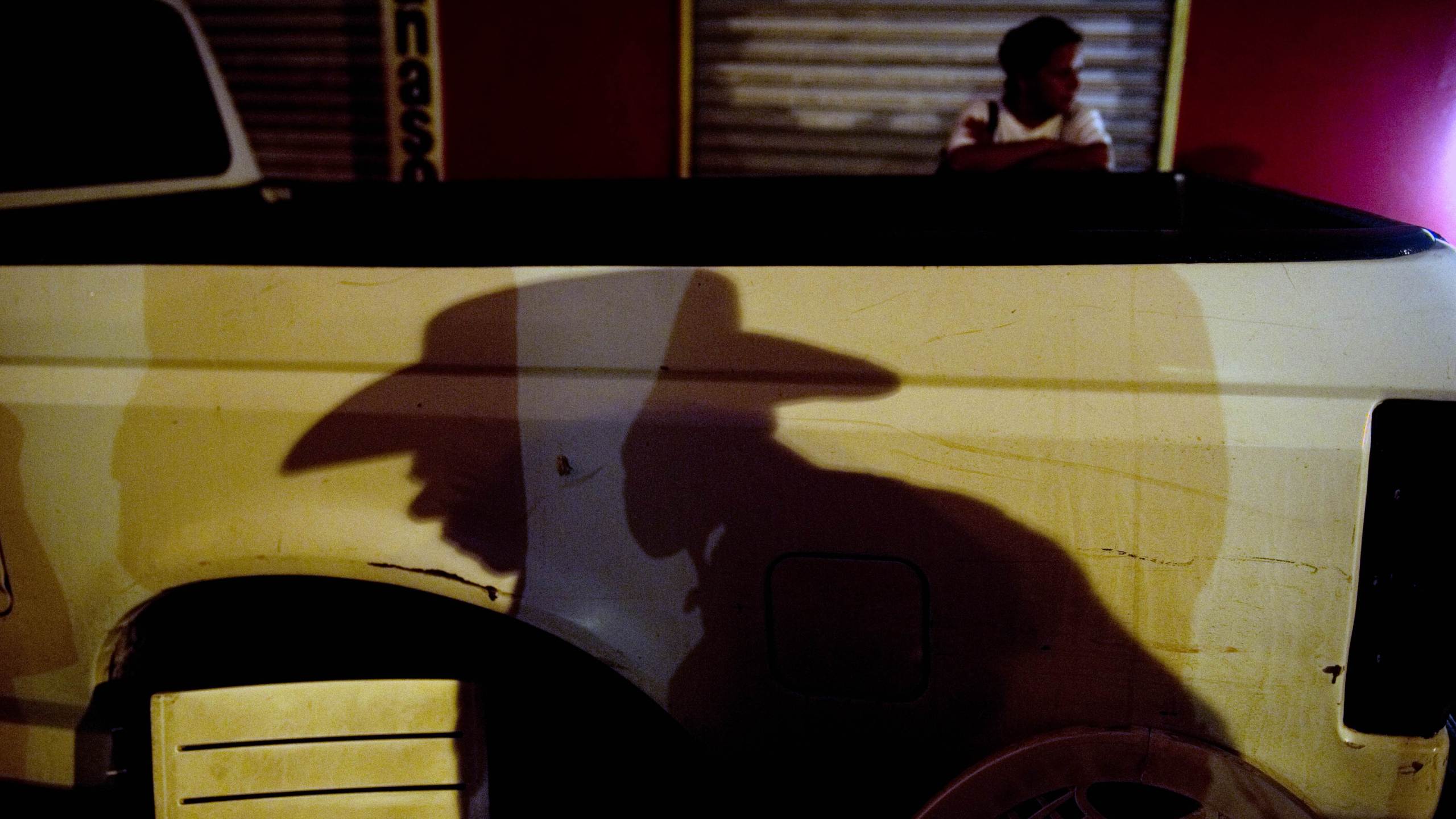 A member of "Los Chirrines", a "corridos" band, waits for clients in a street of Culiacan, Sinaloa state on July 12, 2011. The narcocorridos, Mexico's popular songs glorifying its drug traffickers, have attracted growing support in recent years, from Mexico City to Los Angeles. But authorities in northwestern Sinaloa for the first time banned the ballads last May, surprising many in the home state of Mexico's oldest, Sinaloa cartel, where drug trafficking and its often ostentatious culture are omnipresent. AFP PHOTO/Yuri CORTEZ (Photo credit should read YURI CORTEZ/AFP via Getty Images)