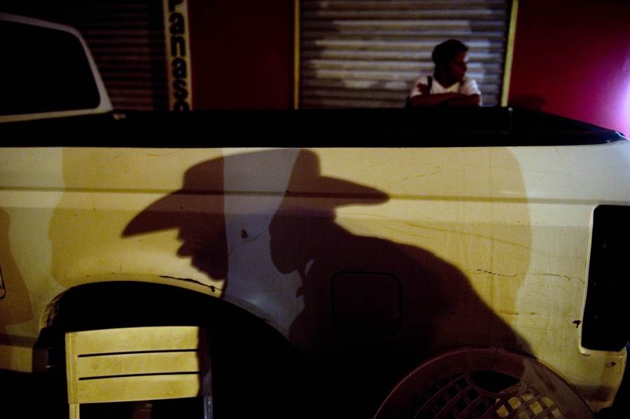 A member of "Los Chirrines", a "corridos" band, waits for clients in a street of Culiacan, Sinaloa state on July 12, 2011. The narcocorridos, Mexico's popular songs glorifying its drug traffickers, have attracted growing support in recent years, from Mexico City to Los Angeles. But authorities in northwestern Sinaloa for the first time banned the ballads last May, surprising many in the home state of Mexico's oldest, Sinaloa cartel, where drug trafficking and its often ostentatious culture are omnipresent. AFP PHOTO/Yuri CORTEZ (Photo credit should read YURI CORTEZ/AFP via Getty Images)