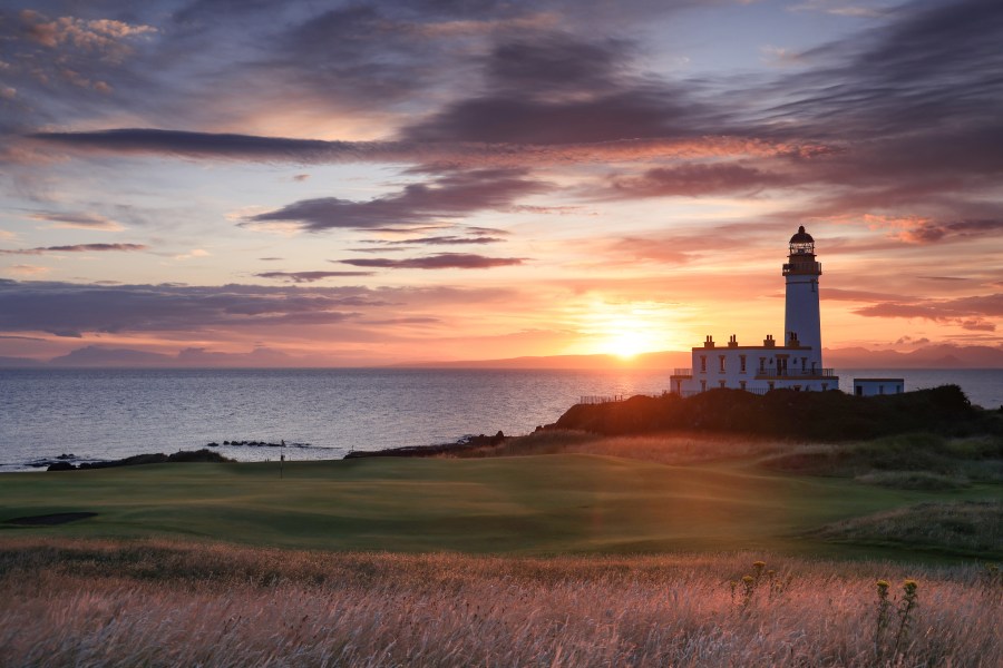 A view of the green on the par 3, ninth hole beside The Turnberry Lighthouse as sunset on the Ailsa golf course at Trump Turnberry resort in Scotland.