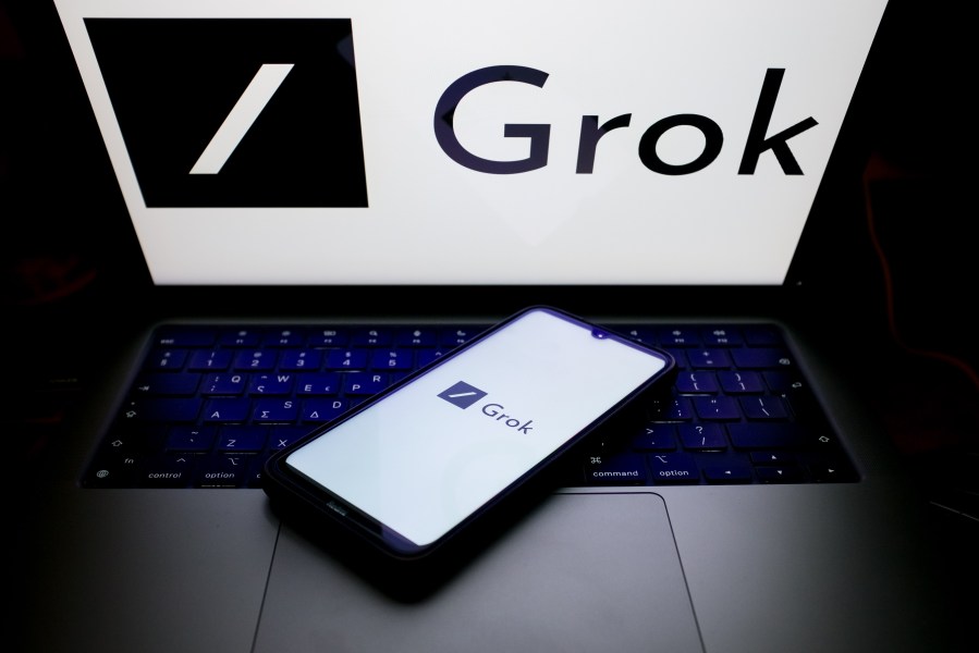 The Grok logo displayed on a smartphone screen and on a computer screen.