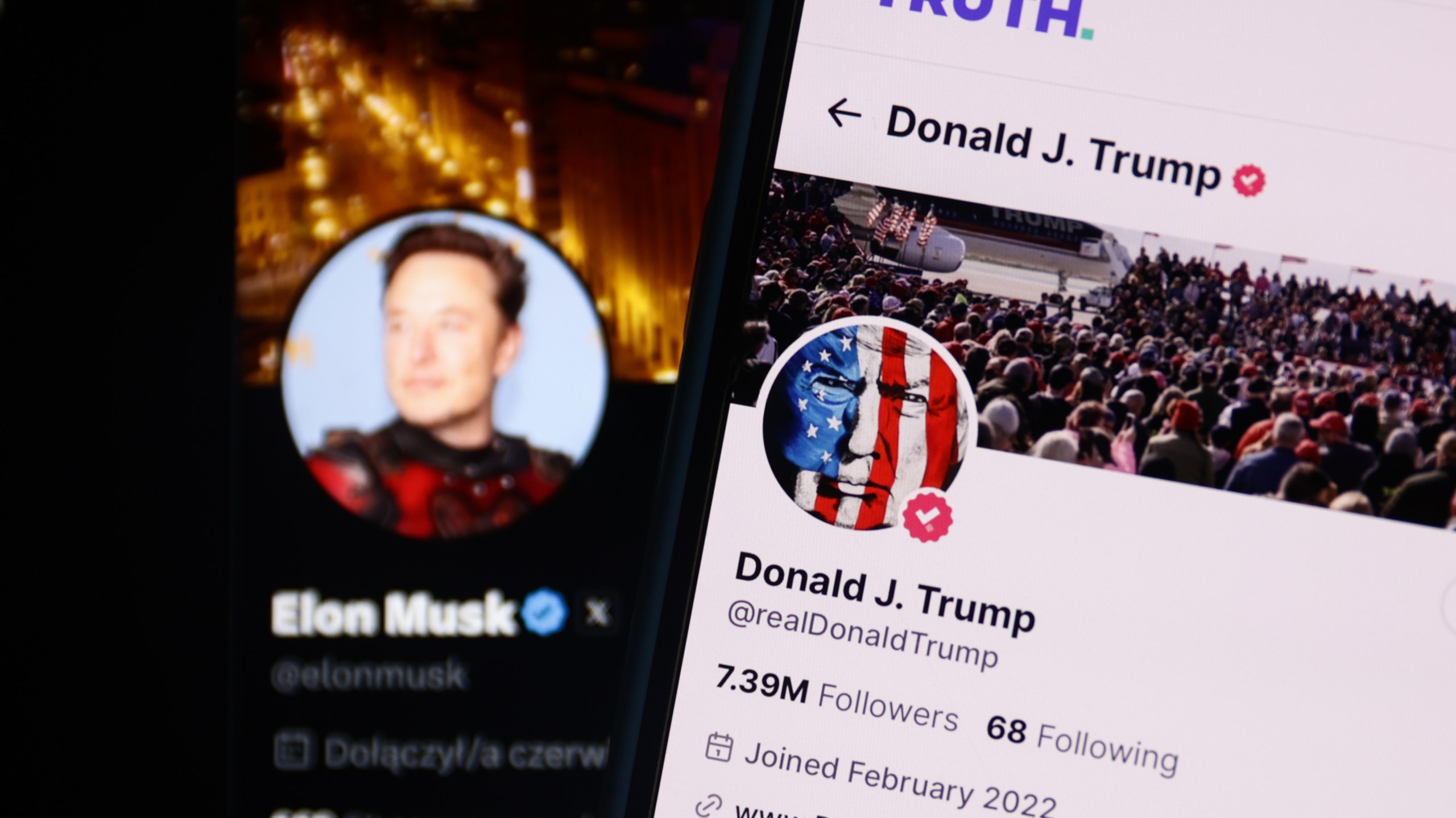 Elon Musk account on X displayed on a laptop screen and Donald Trump account on Truth displayed on a phone screen