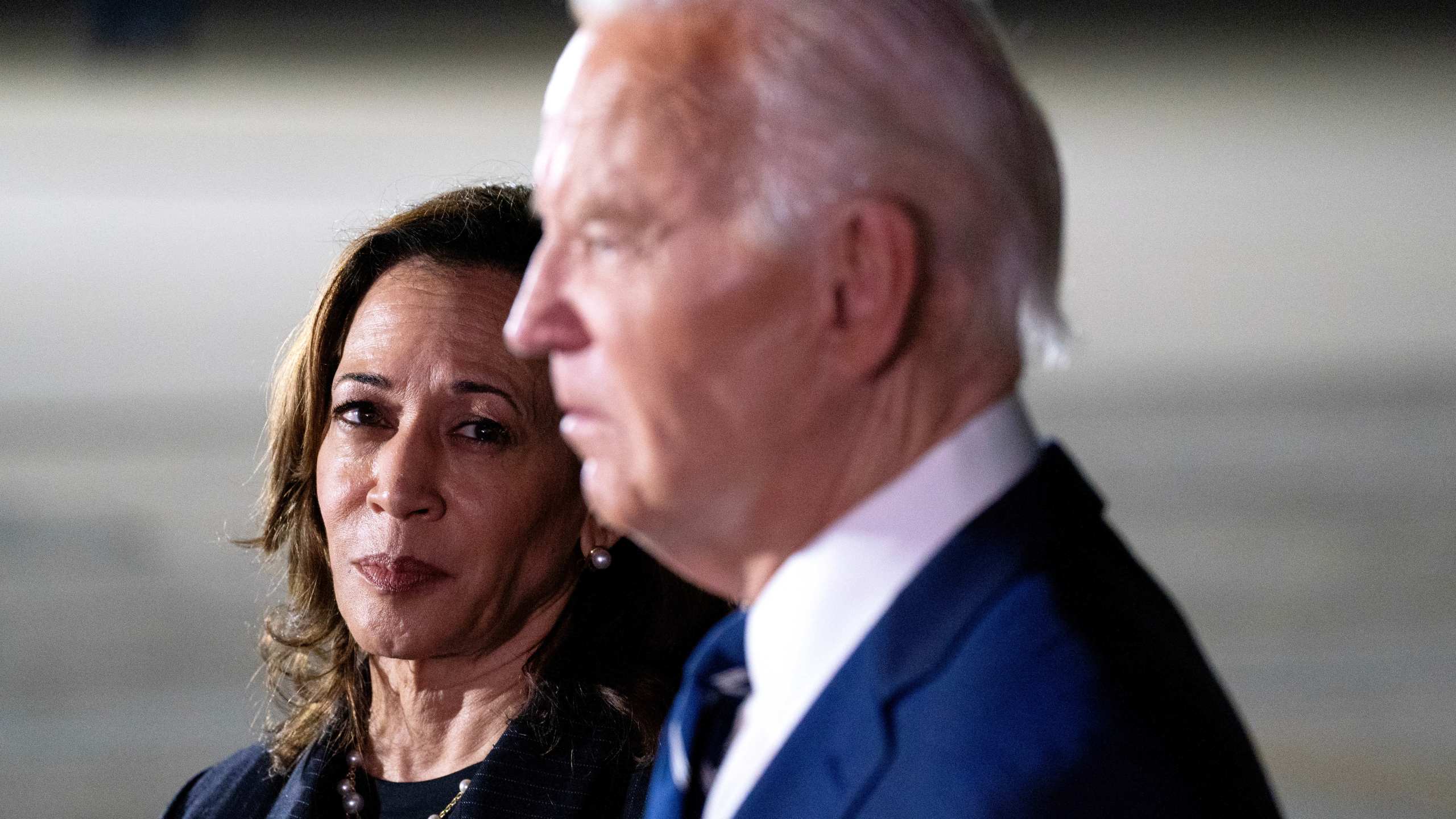 President Joe Biden, flanked by Vice President Kamala Harris, talk to reporters at Joint Base Andrews on August first.