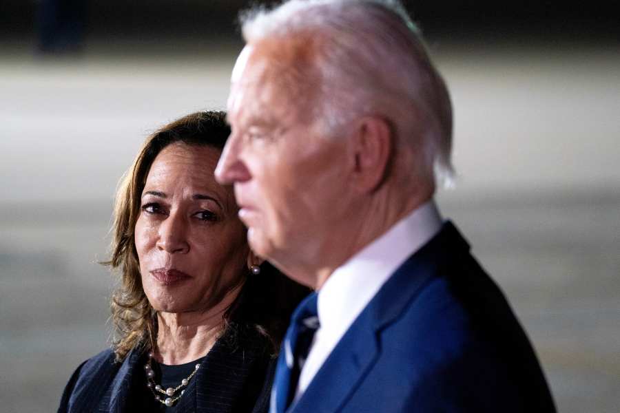 President Joe Biden, flanked by Vice President Kamala Harris, talk to reporters at Joint Base Andrews on August first.