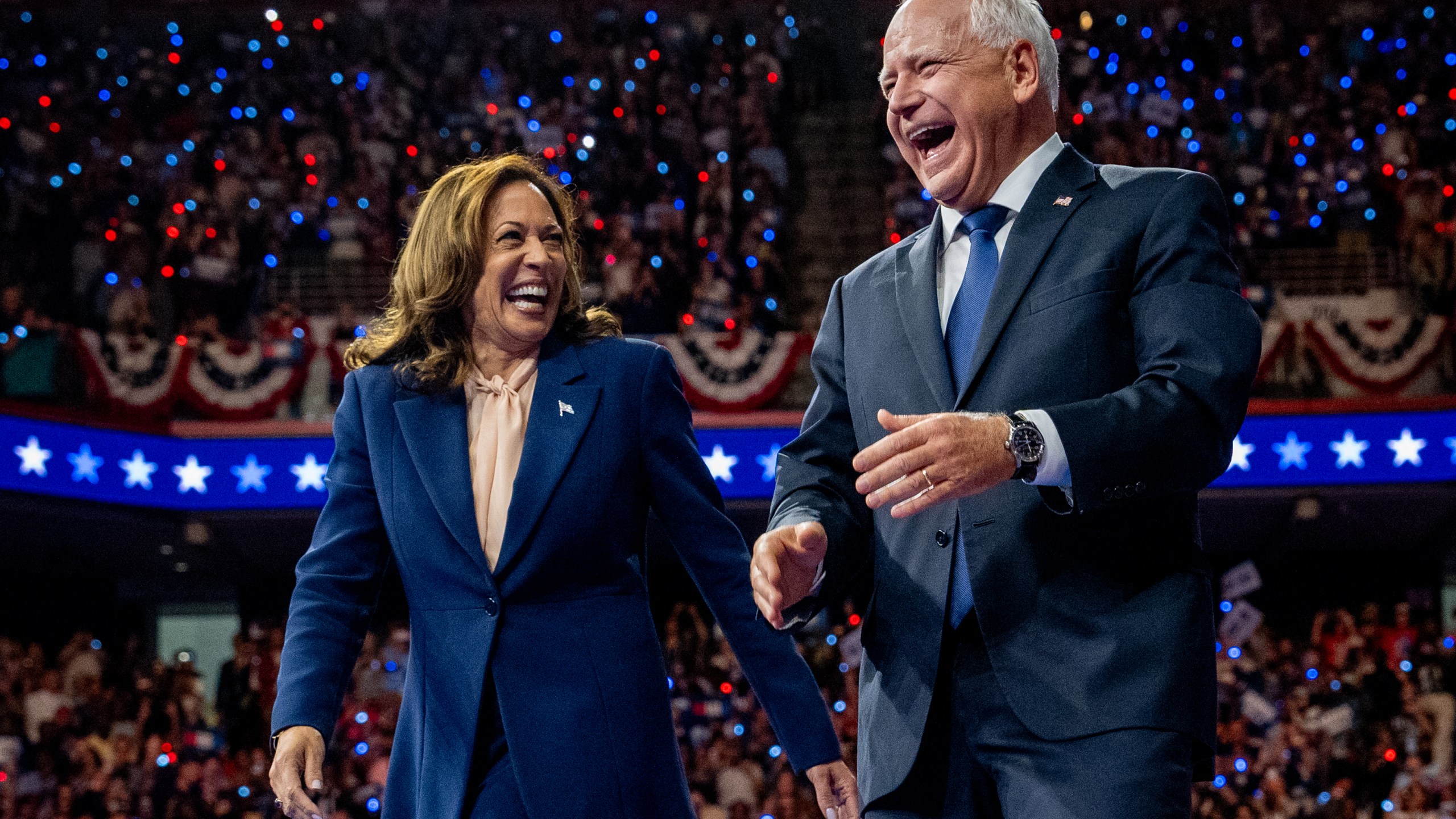 U.S. Vice President Kamala Harris and Democratic vice presidential nominee Minnesota Gov. Tim Walz walk out on stage together.