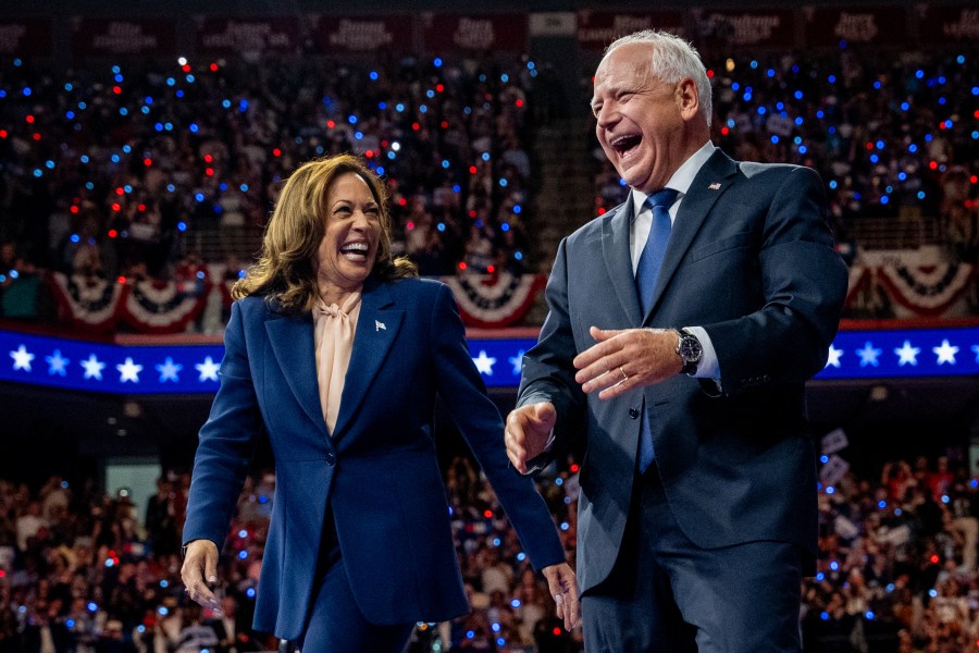 U.S. Vice President Kamala Harris and Democratic vice presidential nominee Minnesota Gov. Tim Walz walk out on stage together.